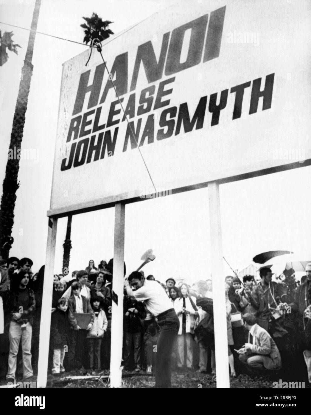 South San Gabriel, California:  March 6, 1973 U.S. Air Force Captain John Nasmyth, Jr., chops down a billboard erected by his family in front of their home while he was a prisoner of war in North Vietnam. The family vowed it would stay up until Nasmyth chopped it down himself. Stock Photo