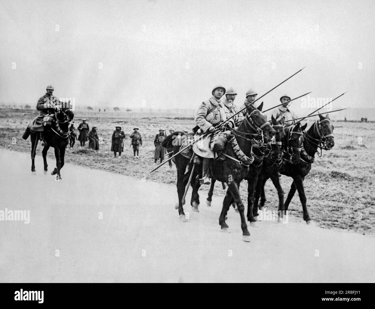 British Western Front, France:  May 3, 1918 A French cavalry patrol passing some British troops on the road. Stock Photo