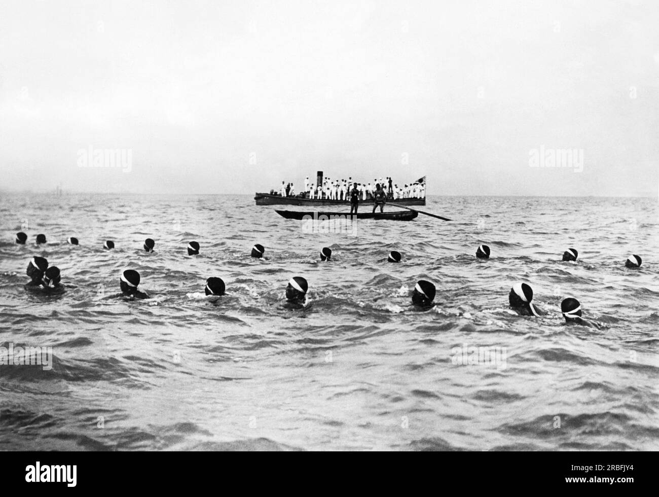 Japan:  c. 1926 Japanese Navy sailors taking part in the annual 20 mile swim form the Naval base at Yokosuka to the Shinagawa ward in Tokyo. It is one of Japan's most popular sporting events. Stock Photo