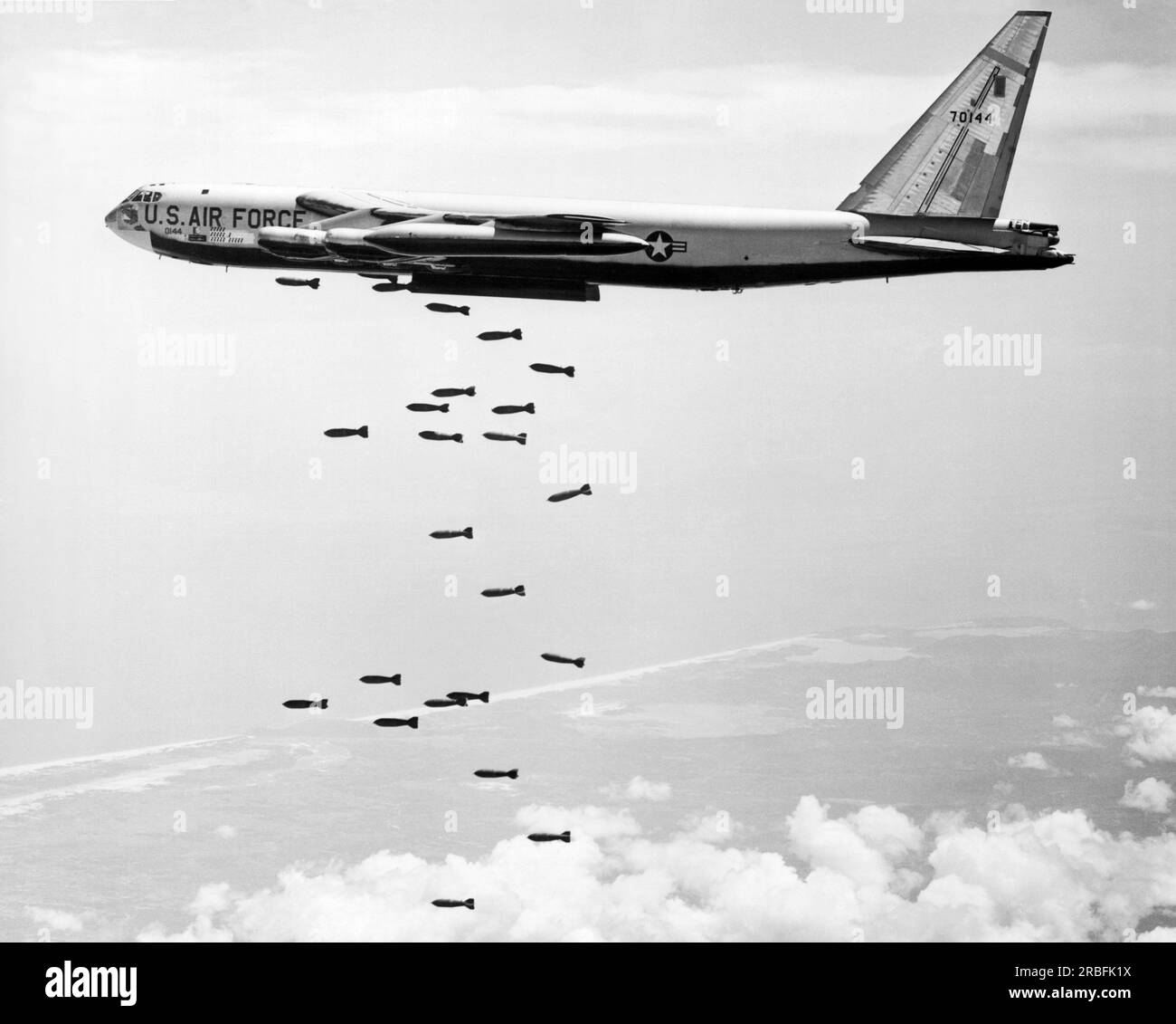 Vietnam:  October 30, 1965 A U.S. Air Force SAC B-52 Stratofortress releases a string of 750 pound bombs over a coastal Viet Cong target. Stock Photo