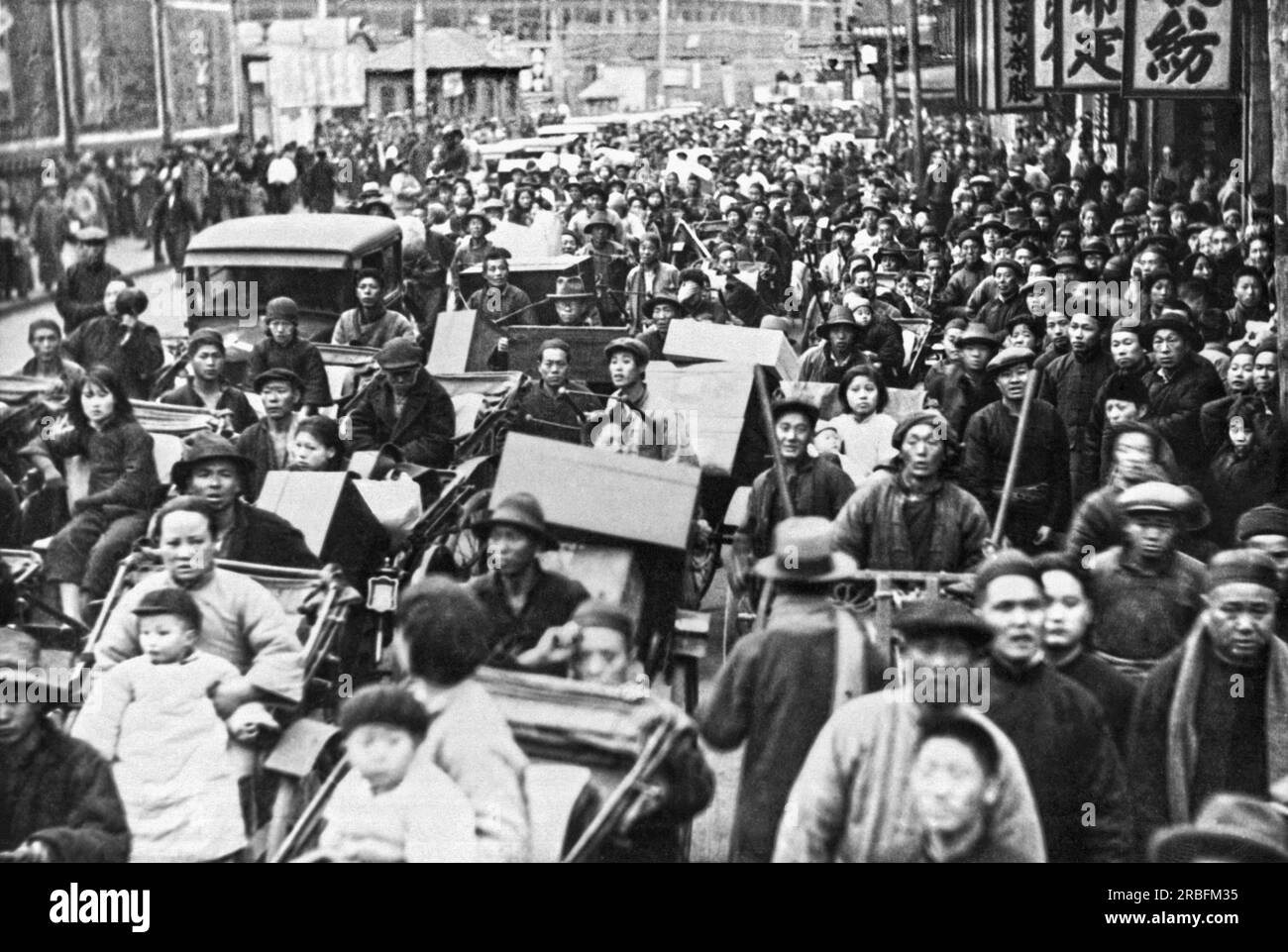 Shanghai, China:  February 22, 1932 Refugees fleeeing from the Chapei district in Shanghai to the Shanghai International Settlement after a Japanese airplane bombing. Stock Photo