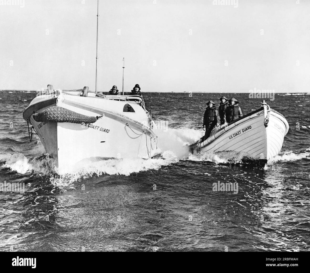 United States:  c. 1945 The small boat equipment at every U.S. Coast Guard Surf Station. On the left is a self-righting and self-bailing motor life boat, designed for the heaviest seas, and at the right is a motor surf boat suitable for less dangerous conditions. Stock Photo