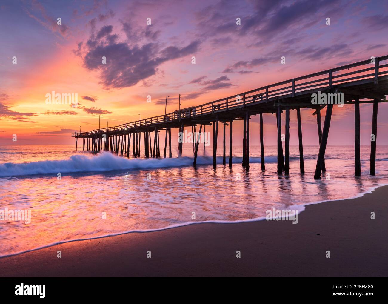 Dramatic sunrise at old wooden pier in Nags Head under dramatic skies