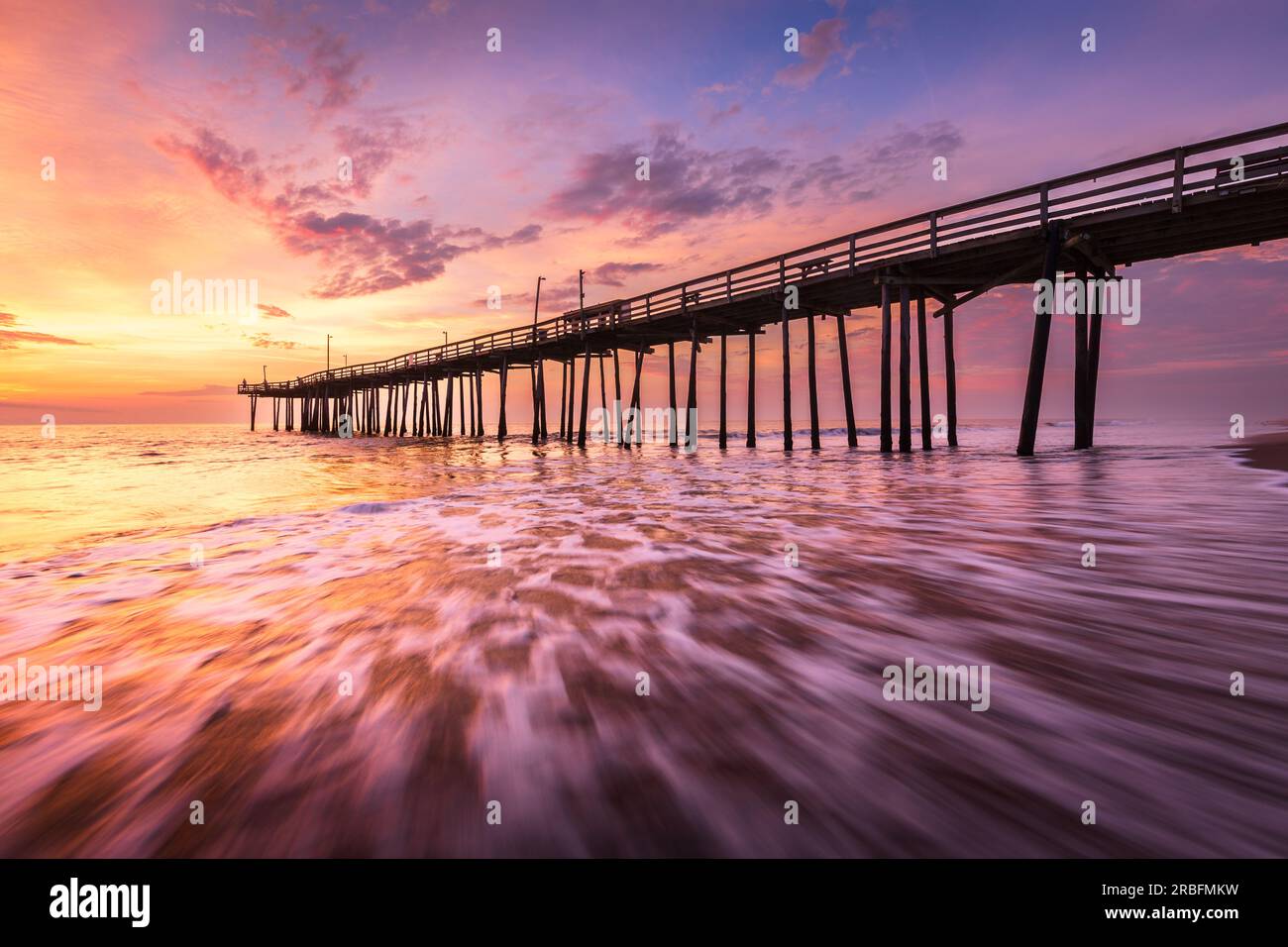 Dramatic sunrise at old wooden pier in Nags Head under dramatic skies