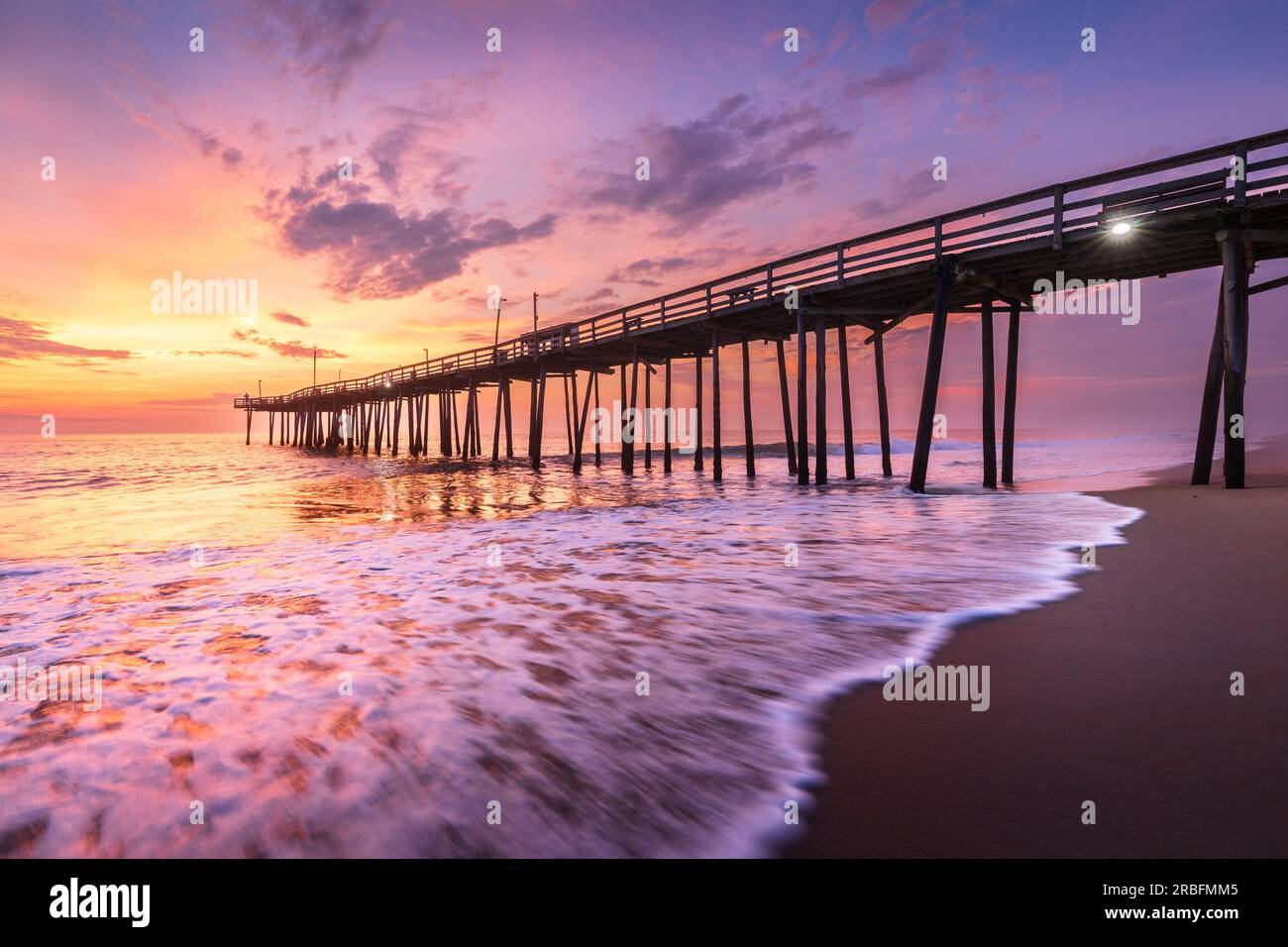 Dramatic sunrise at old wooden pier in Nags Head under dramatic skies