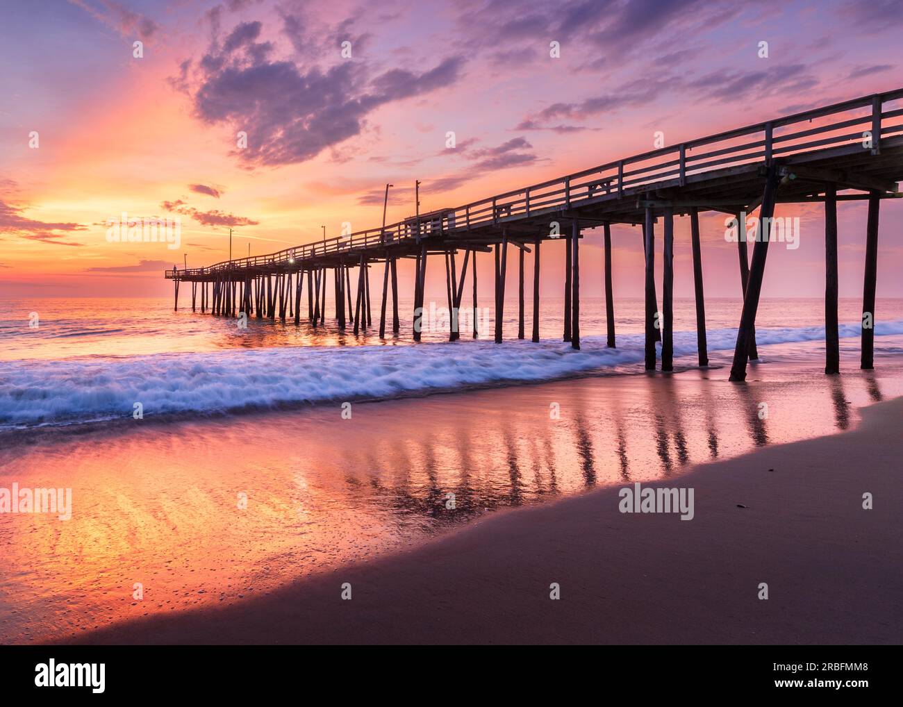 Dramatic sunrise at old wooden pier in Nags Head under dramatic skies