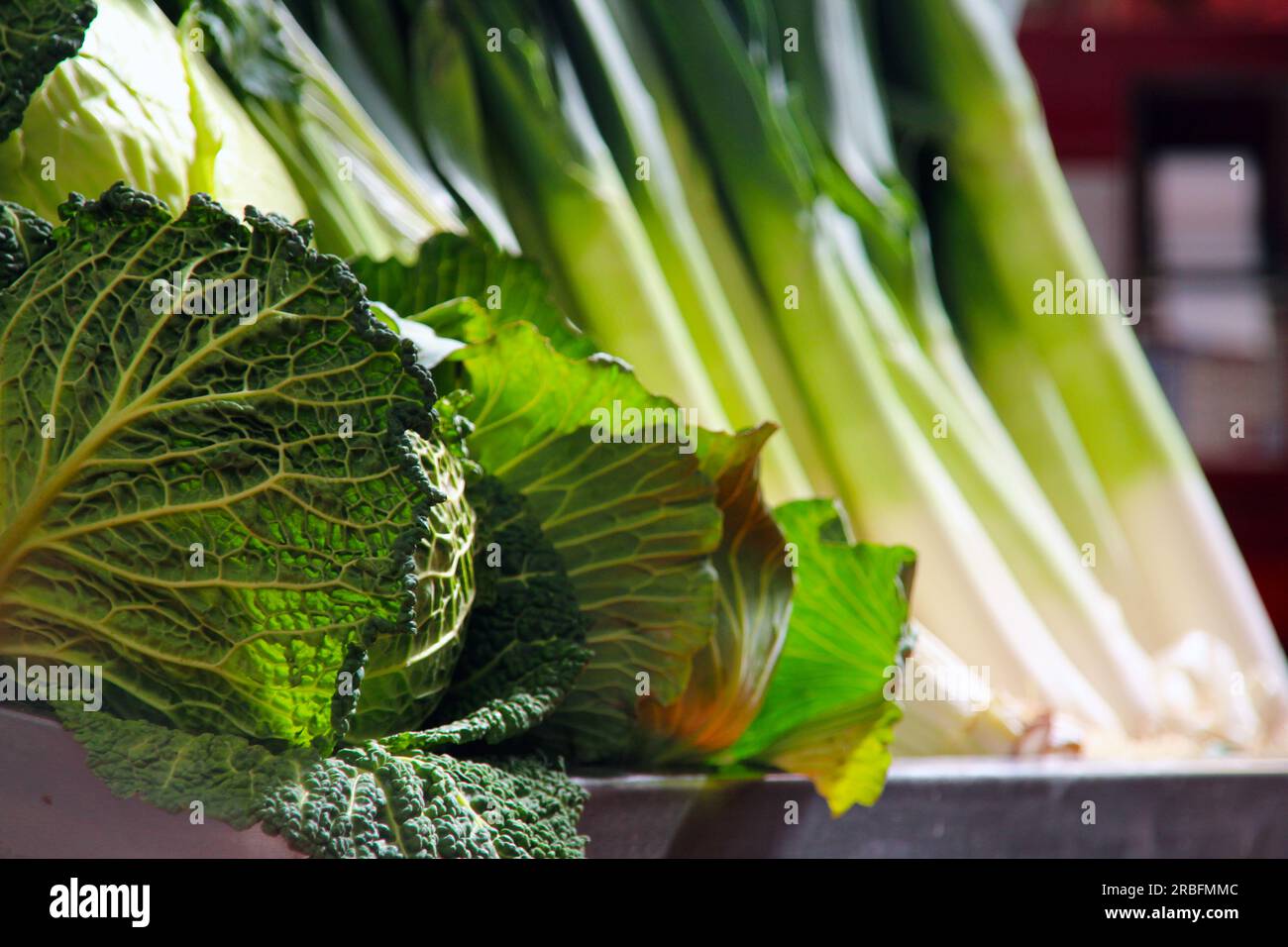 Market stall with backlit cabbages and beetroot Stock Photo