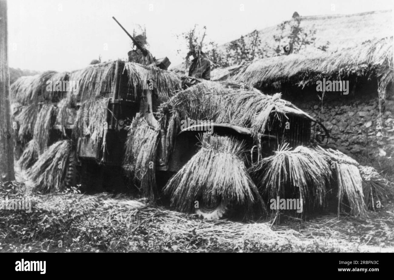 Korea:  July 17, 1950 A U.S. Army truck is camouflaged with rice straw during a stop. A two man crew mans the machine gun atop the vehicle Stock Photo