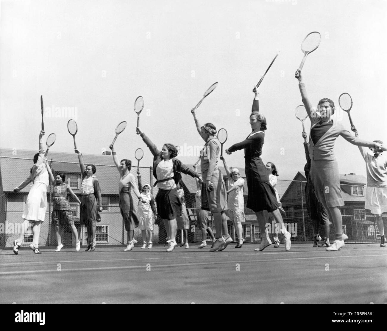 New Brunswick, New Jersey:  c. 1922 Women students at the State College For Women practice their tennis serve. Stock Photo