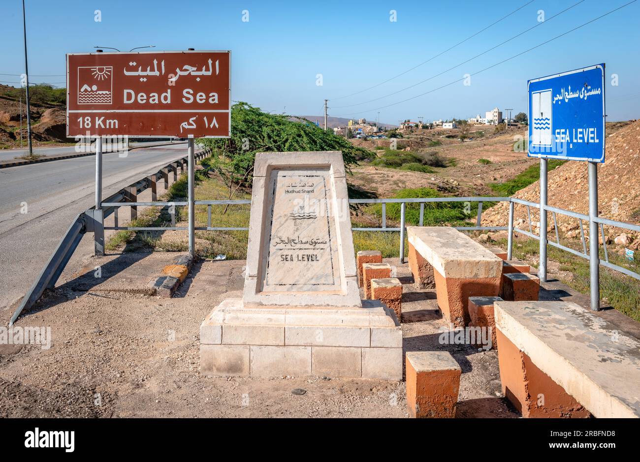 Dead Sea sign on Highway 65, a north–south highway in Jordan that starts in Aqaba passing through Wadi Araba, and adjacent to the Dead Sea. Stock Photo
