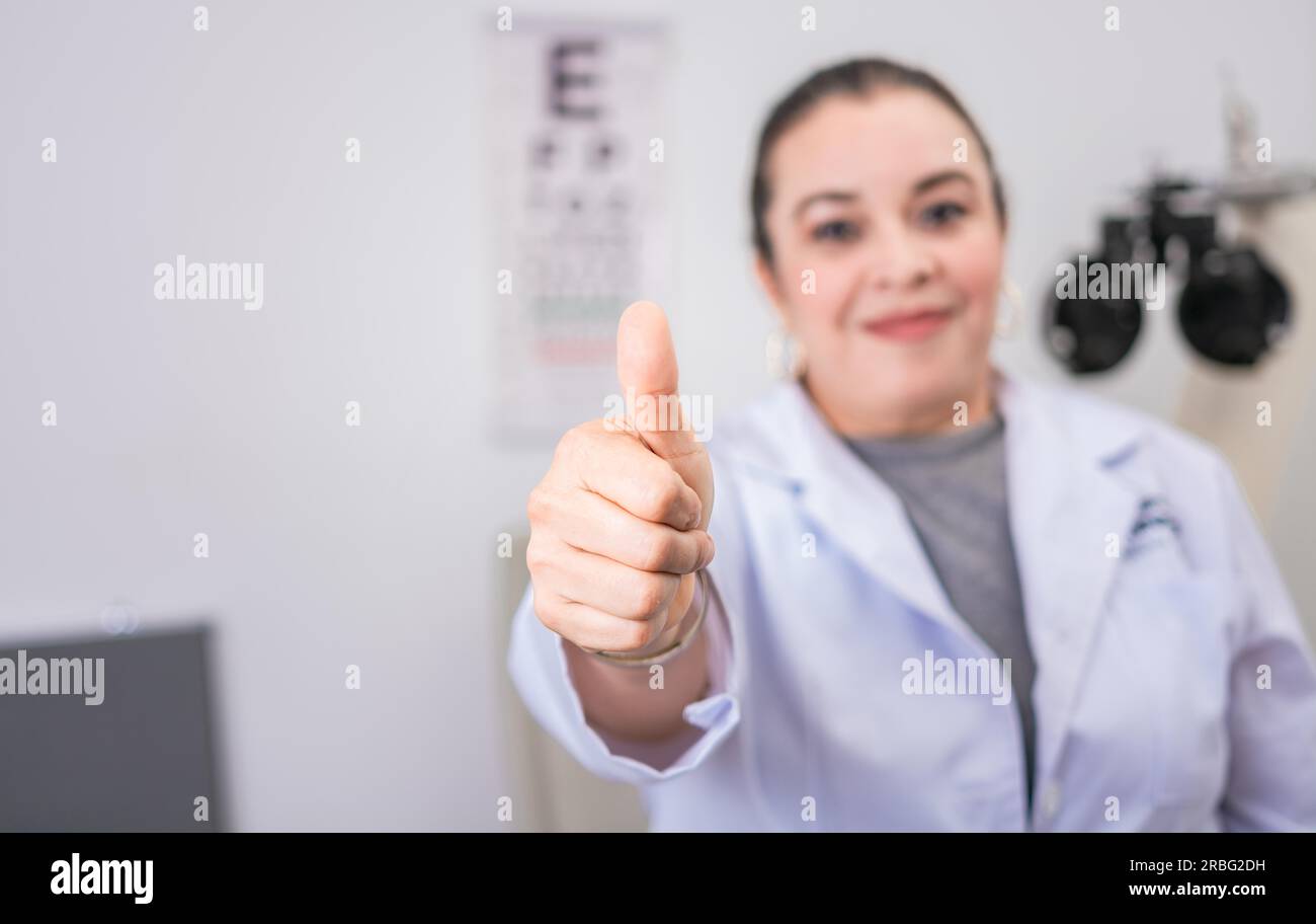 Female optometrist with thumb up in the laboratory. Optometry