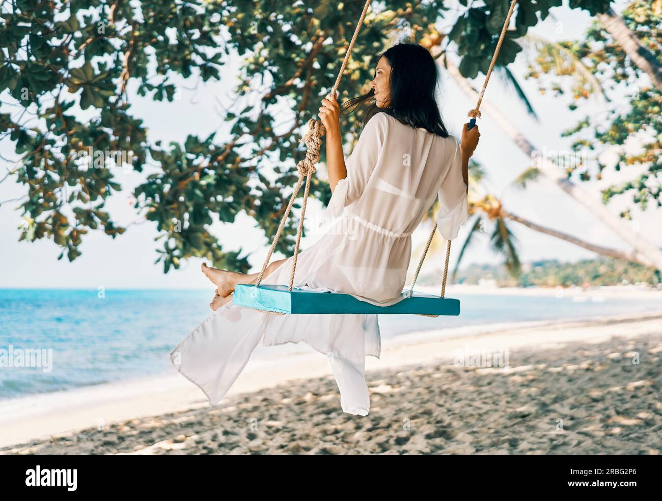Beautiful woman swinging on beach hi-res stock photography and images ...