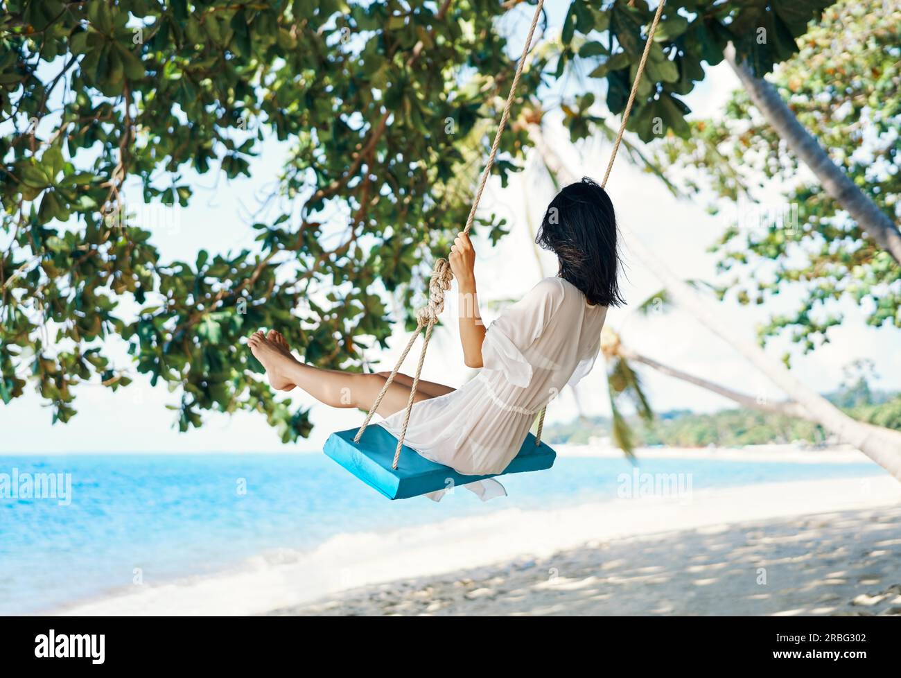 Beautiful woman swinging on beach hi-res stock photography and images ...
