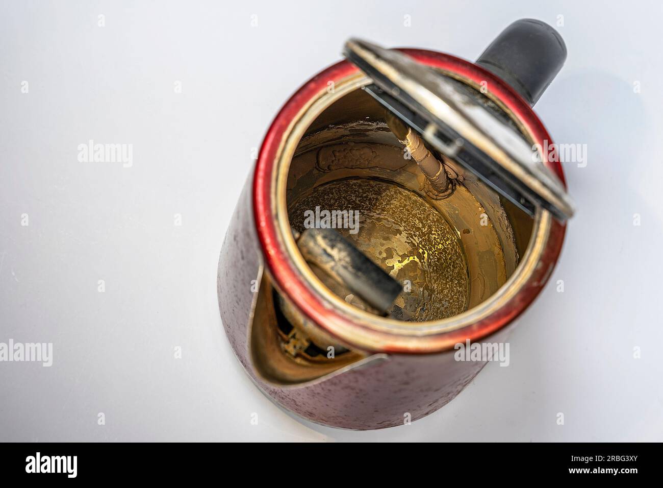 An old electric kettle with traces of scale and limescale on the walls