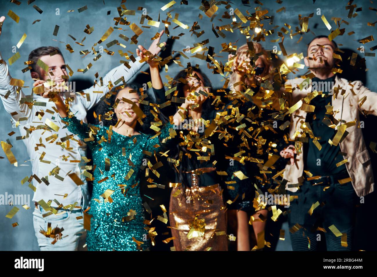 Group of friends enjoying party and throwing confetti. Celebration concept Stock Photo