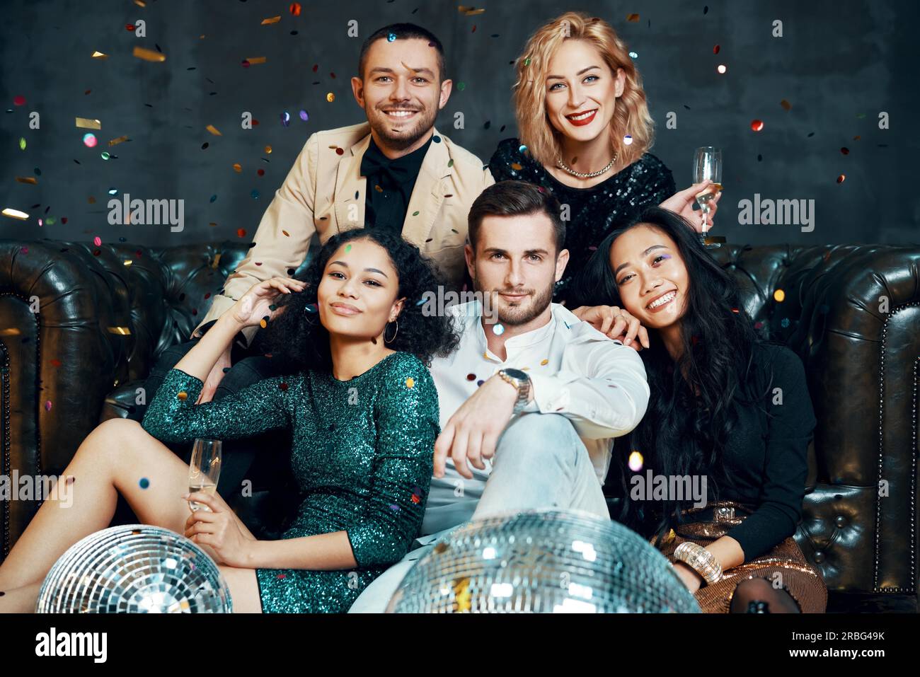 Diverse group of happy young friends having fun enjoying party and drinking champagne. New year, Birthday, celebration concept Stock Photo