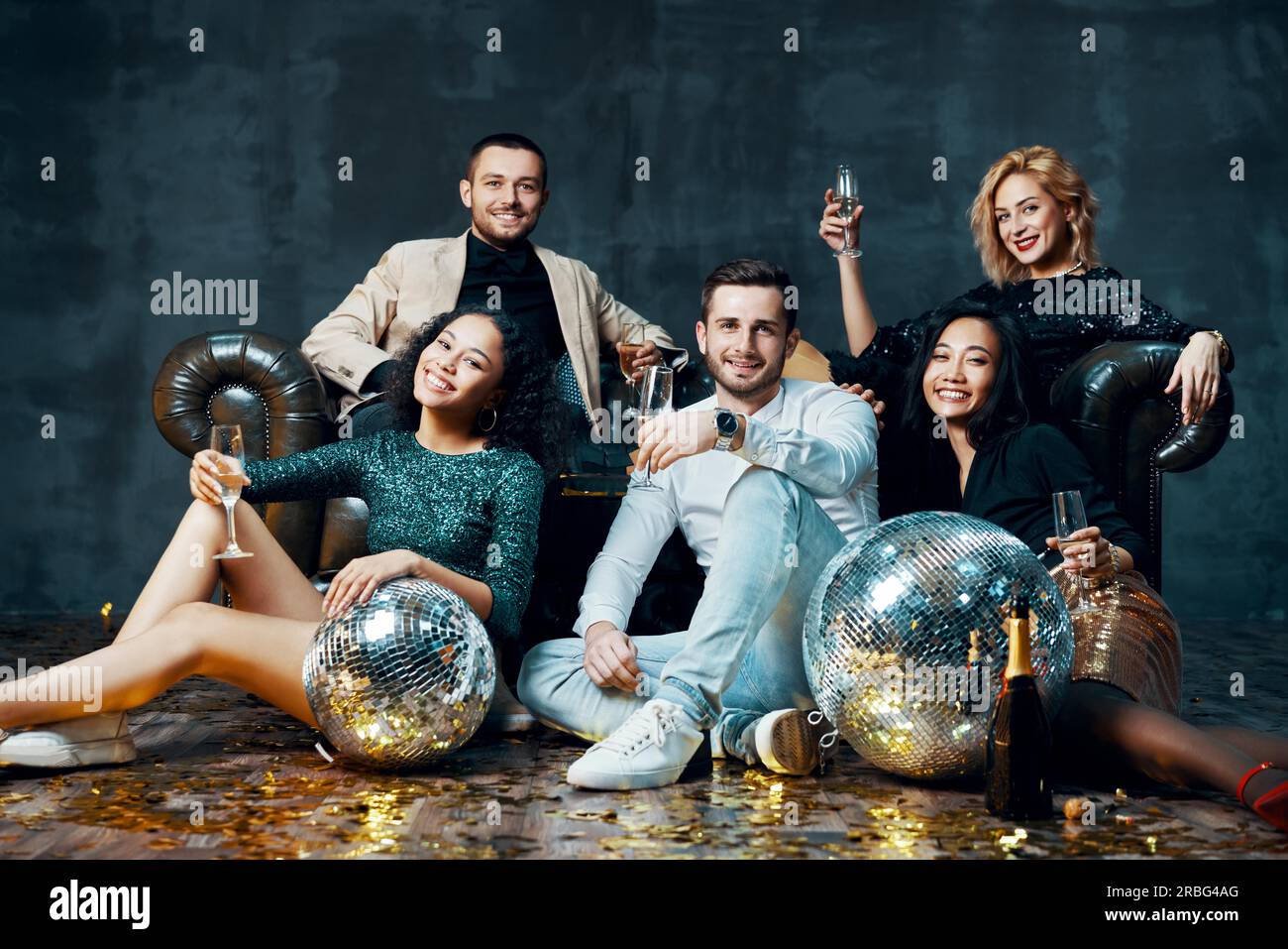 Diverse group of happy young friends having fun enjoying party and drinking champagne. New year, Birthday, celebration concept Stock Photo