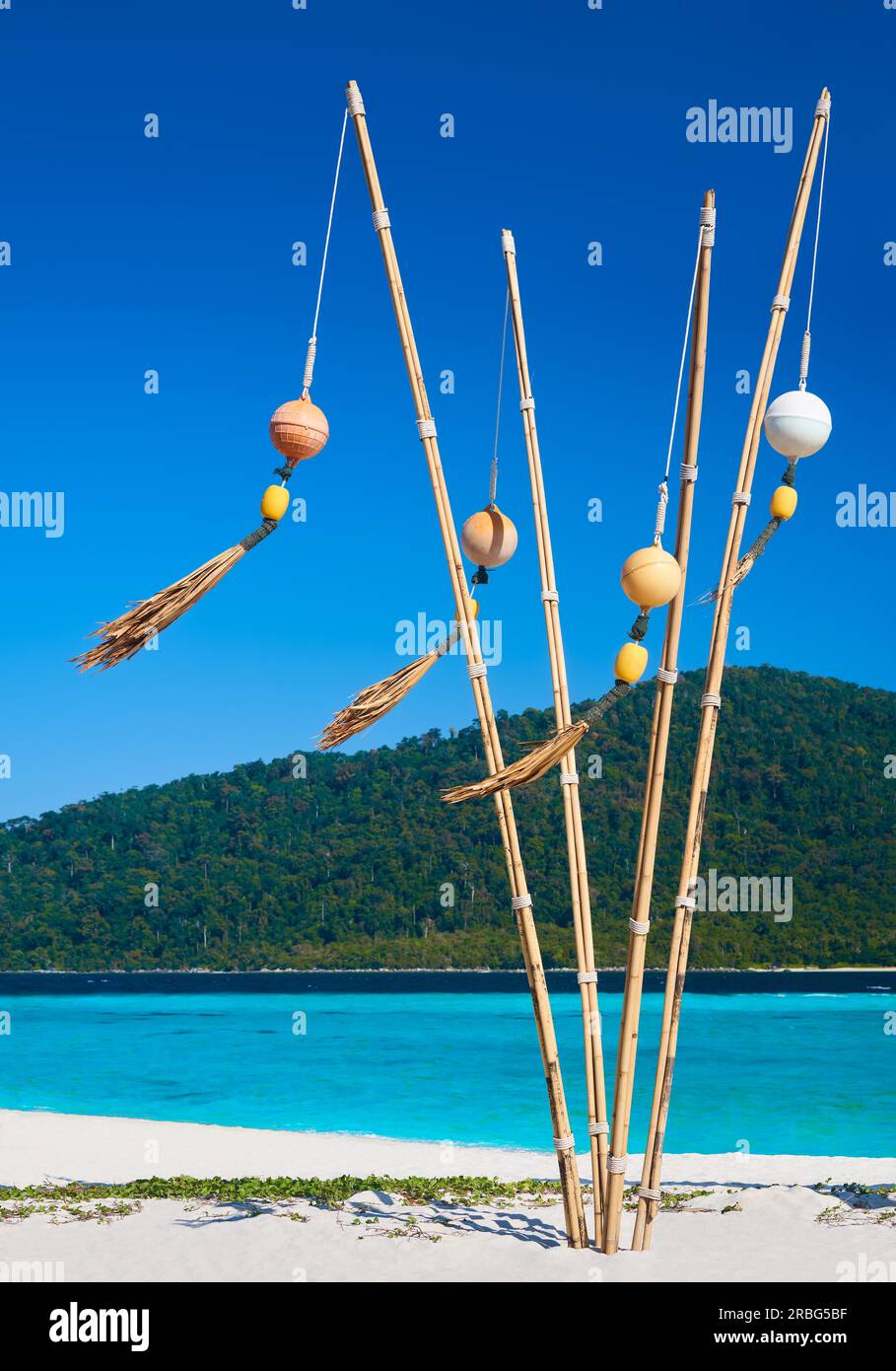 Tropical beach with turquoise clear sea and buoys on bamboo sticks ...