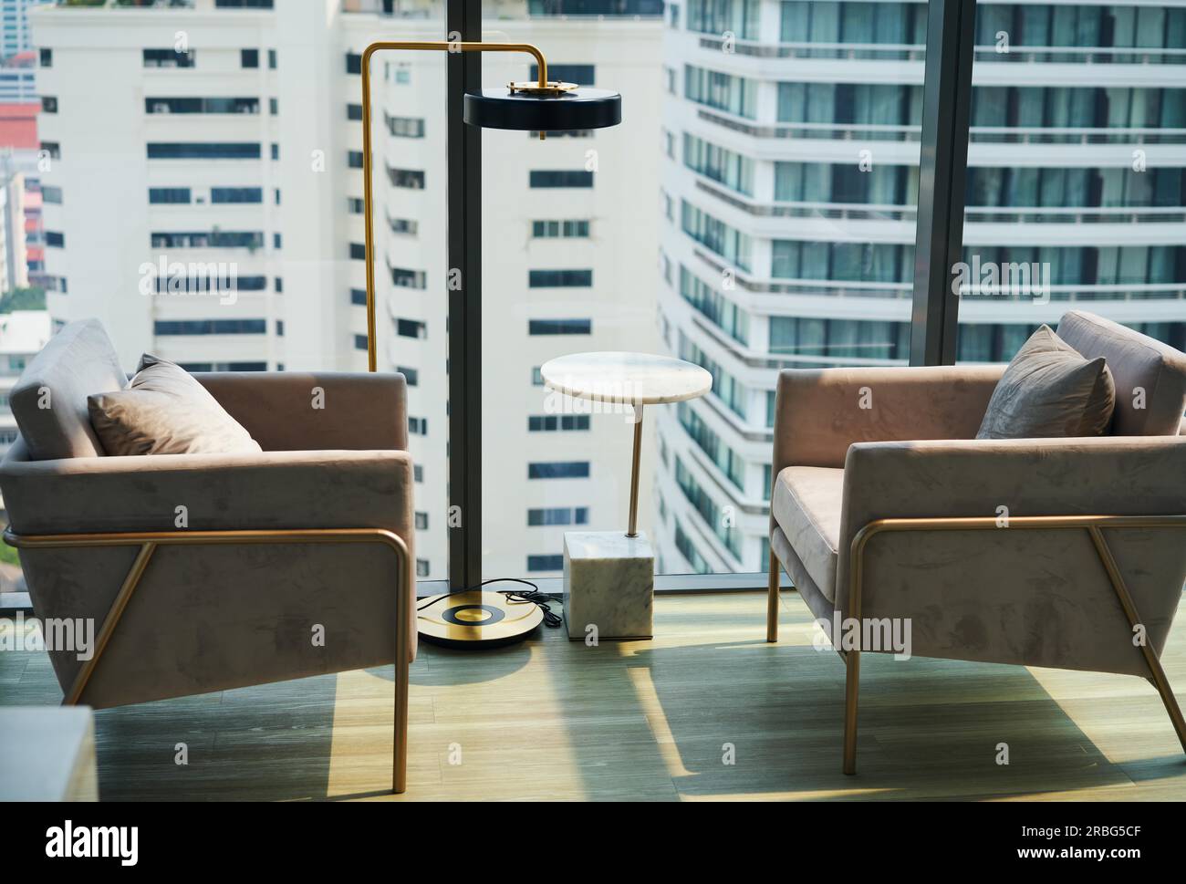 Picture of Armchairs near big window with city view. Modern interior design in ...