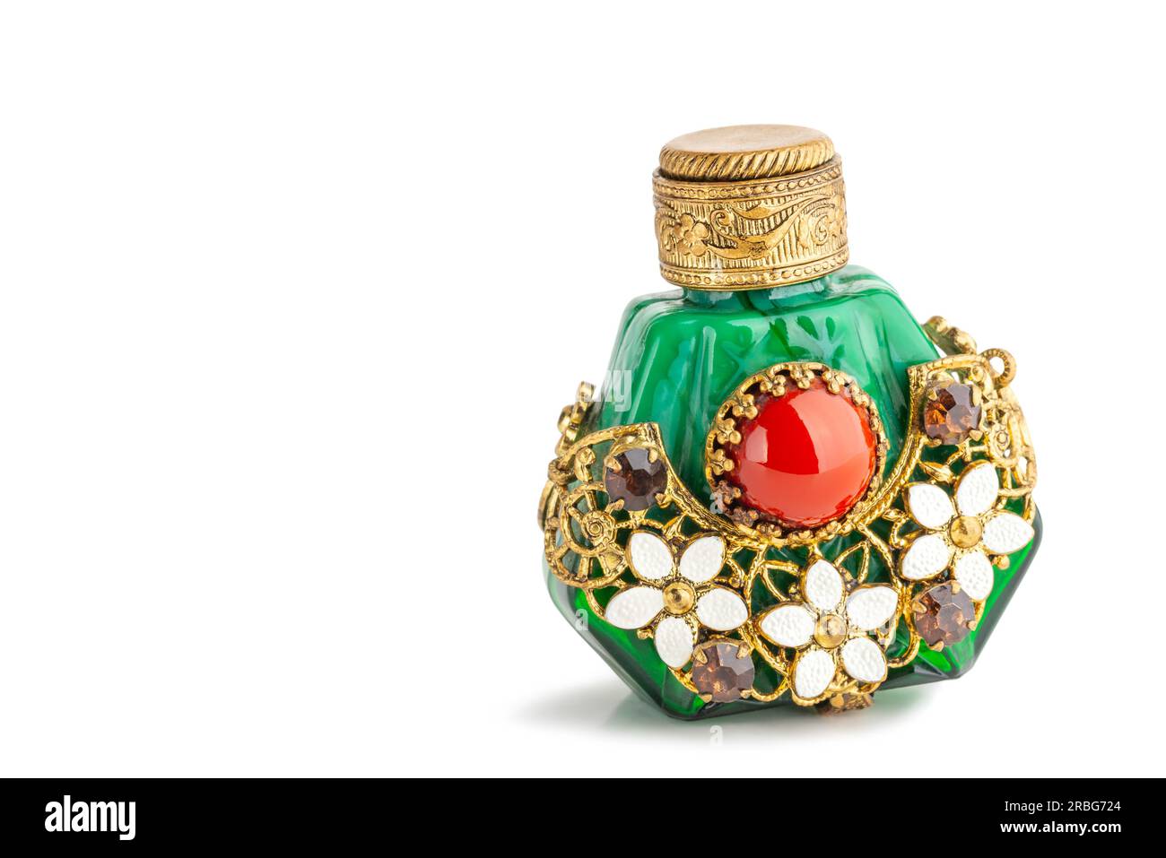 Little oriental perfume bottle in green jade, with brown sinhalite gems and red carnelian stone, ornate with brass filigree and white porcelain Stock Photo