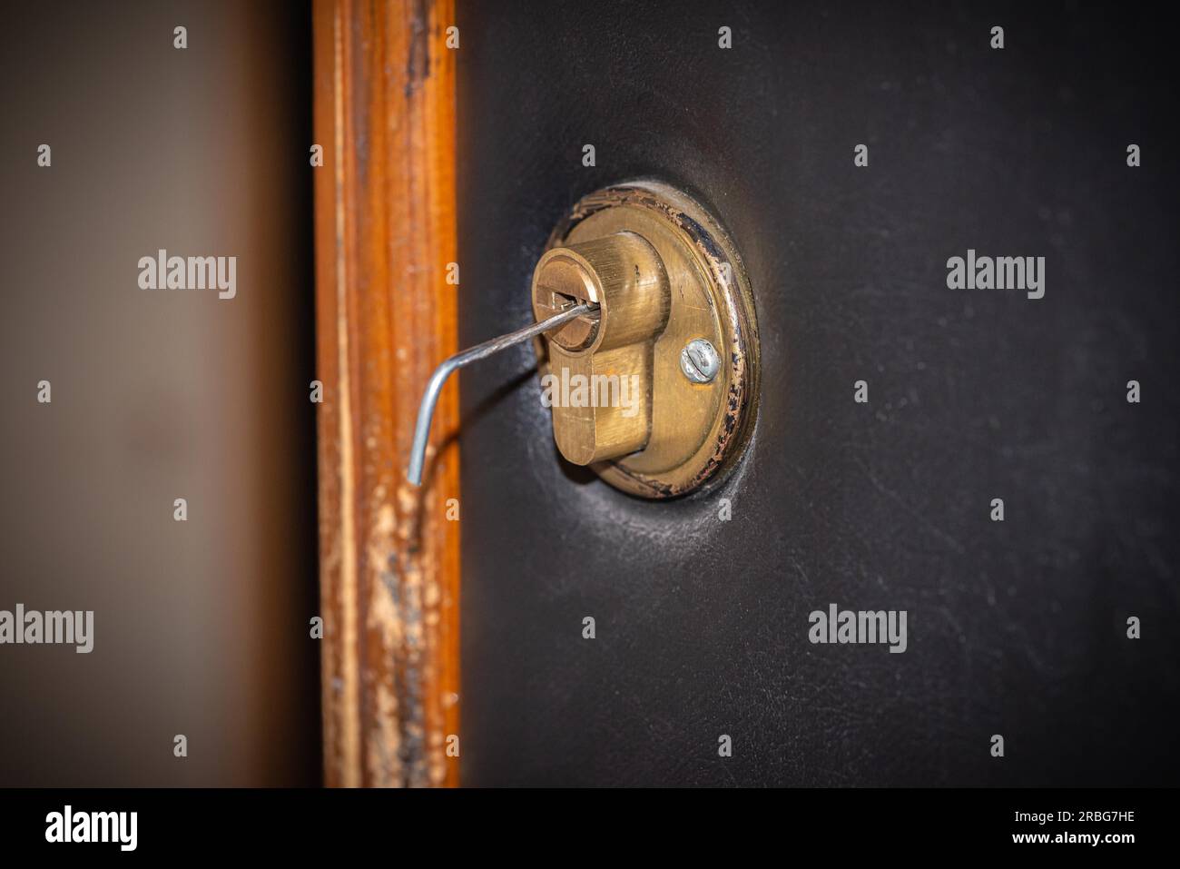 Lock picking, a tension wrench is inserted in the lock of a security