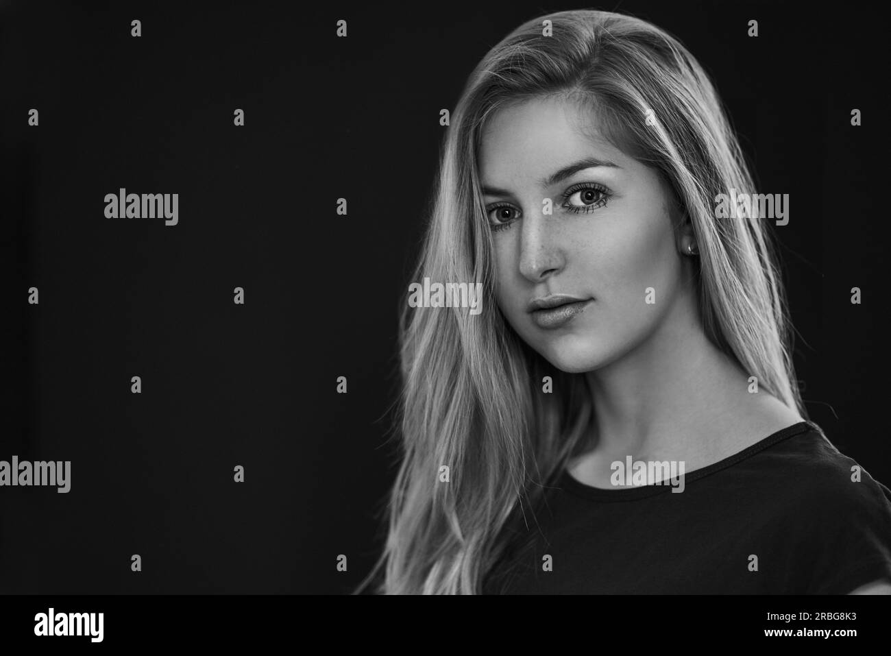 Black and white portrait of beautiful young woman with straight blonde