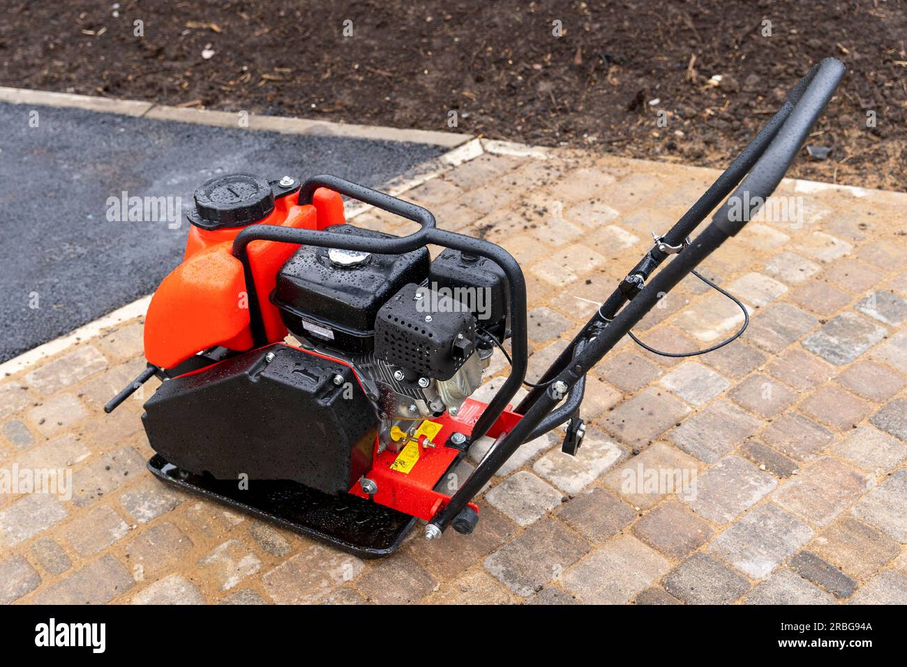 Gasoline Vibrating rammer with a vibrating plate on a construction 