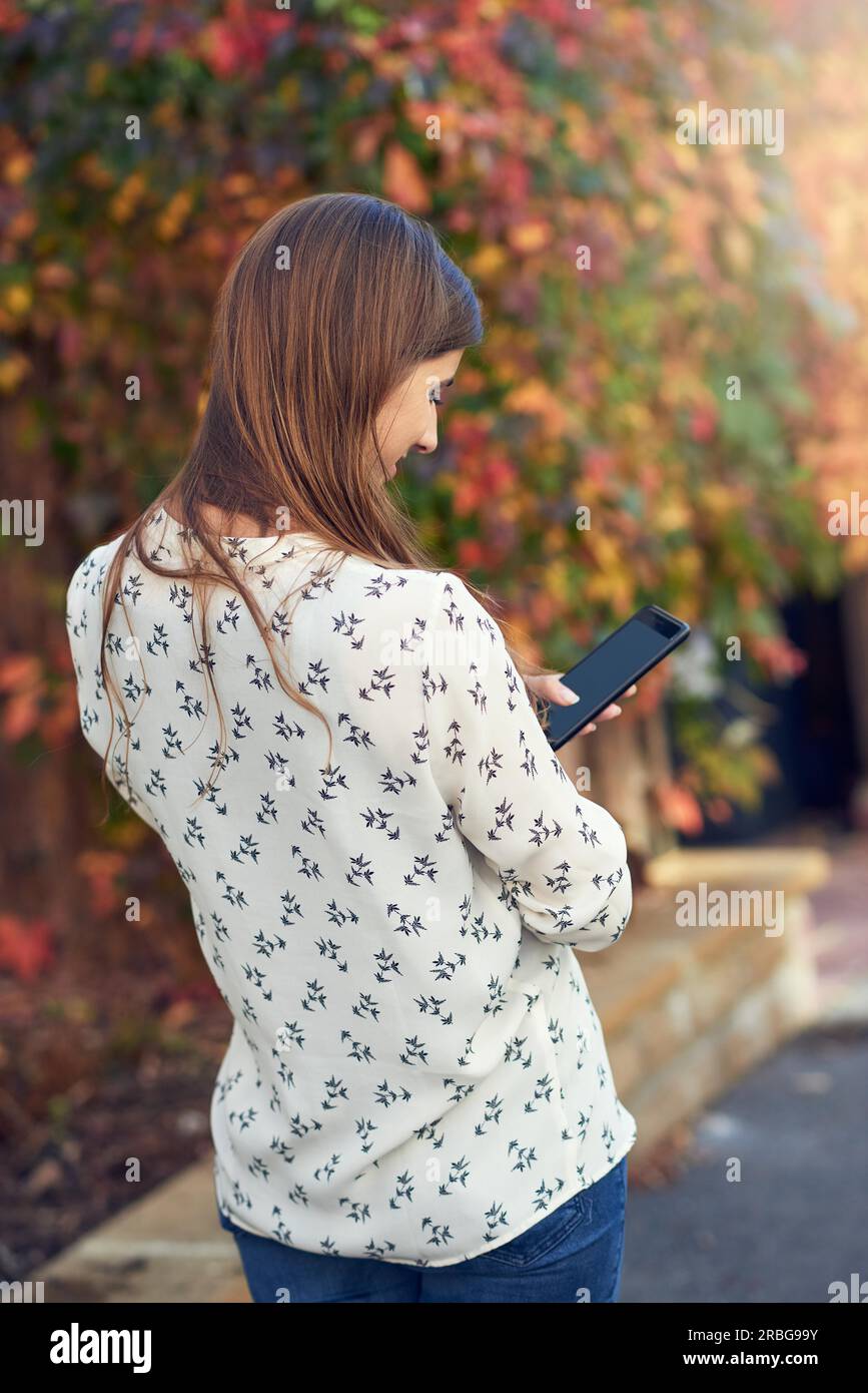 Woman and texting and rear view hi-res stock photography and images - Alamy