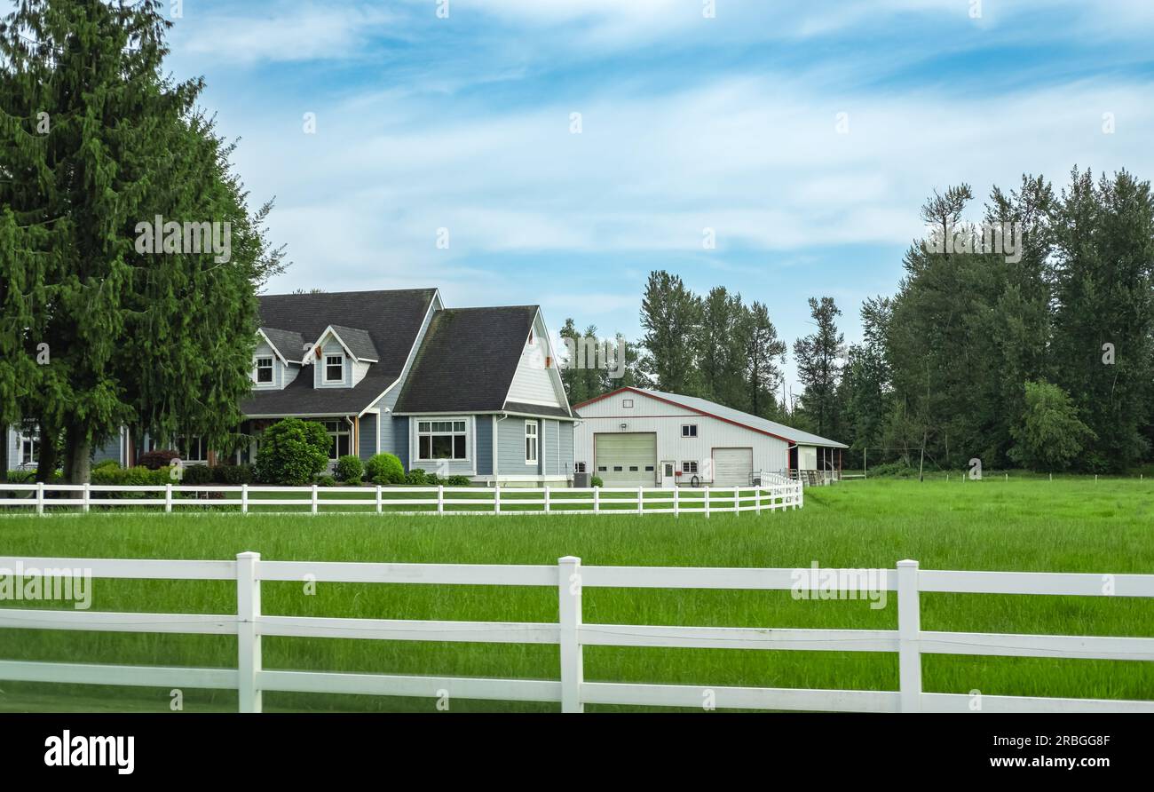 North American Farm country house in the field with fence. Countryside of  Canada. Rural Farmhouse with barns on a sunny day in a summer.Beautiful  hous Stock Photo - Alamy, image size:1300x892