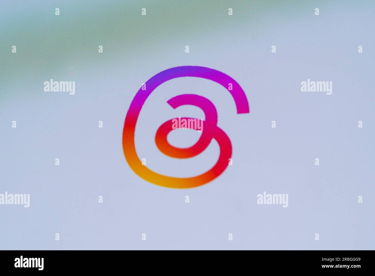 Closeup on a smartphone screen showing the Instagram-like coloured logo for the Threads app, a new application for Instagram by Meta Stock Photo