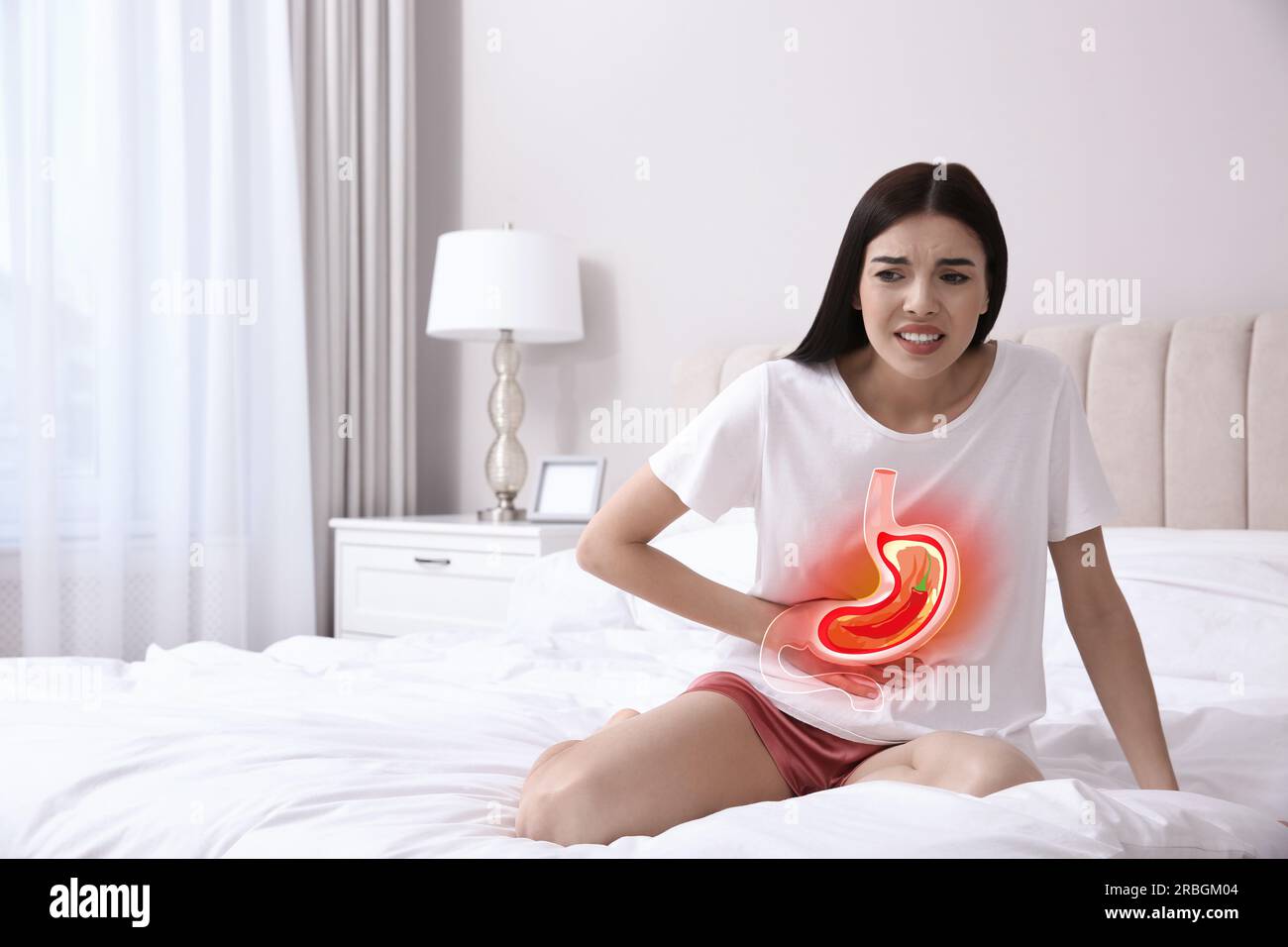 Woman suffering from heartburn at home. Stomach with hot chili pepper symbolizing acid indigestion, illustration Stock Photo