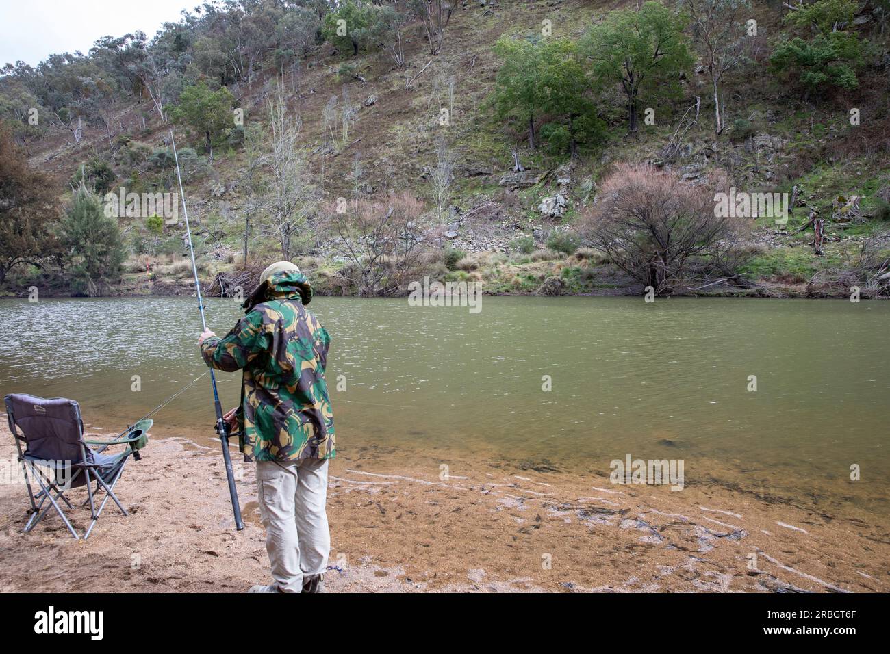 July 2023, Australian man fishing for carp fish in there Macquarie