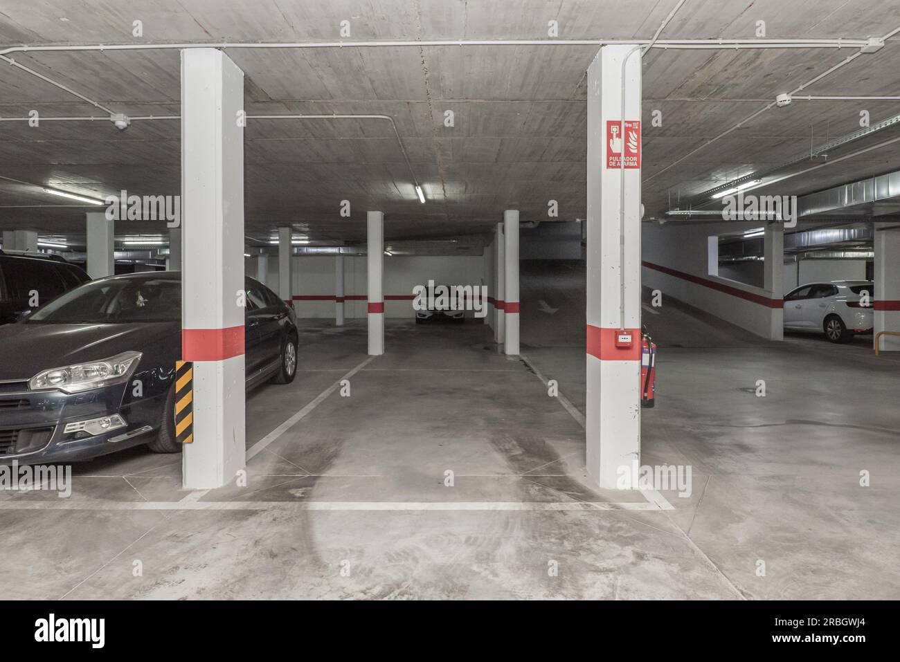 A garage with polished concrete floors and concrete ceilings with many