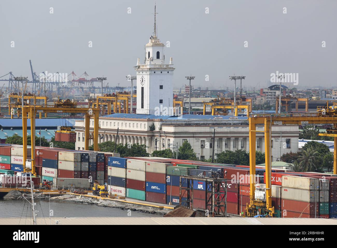 Manila, Philippines : Bureau of Customs building, Philippine Department of Finance, post-World War II reconstruction, containers harbor & port cranes Stock Photo