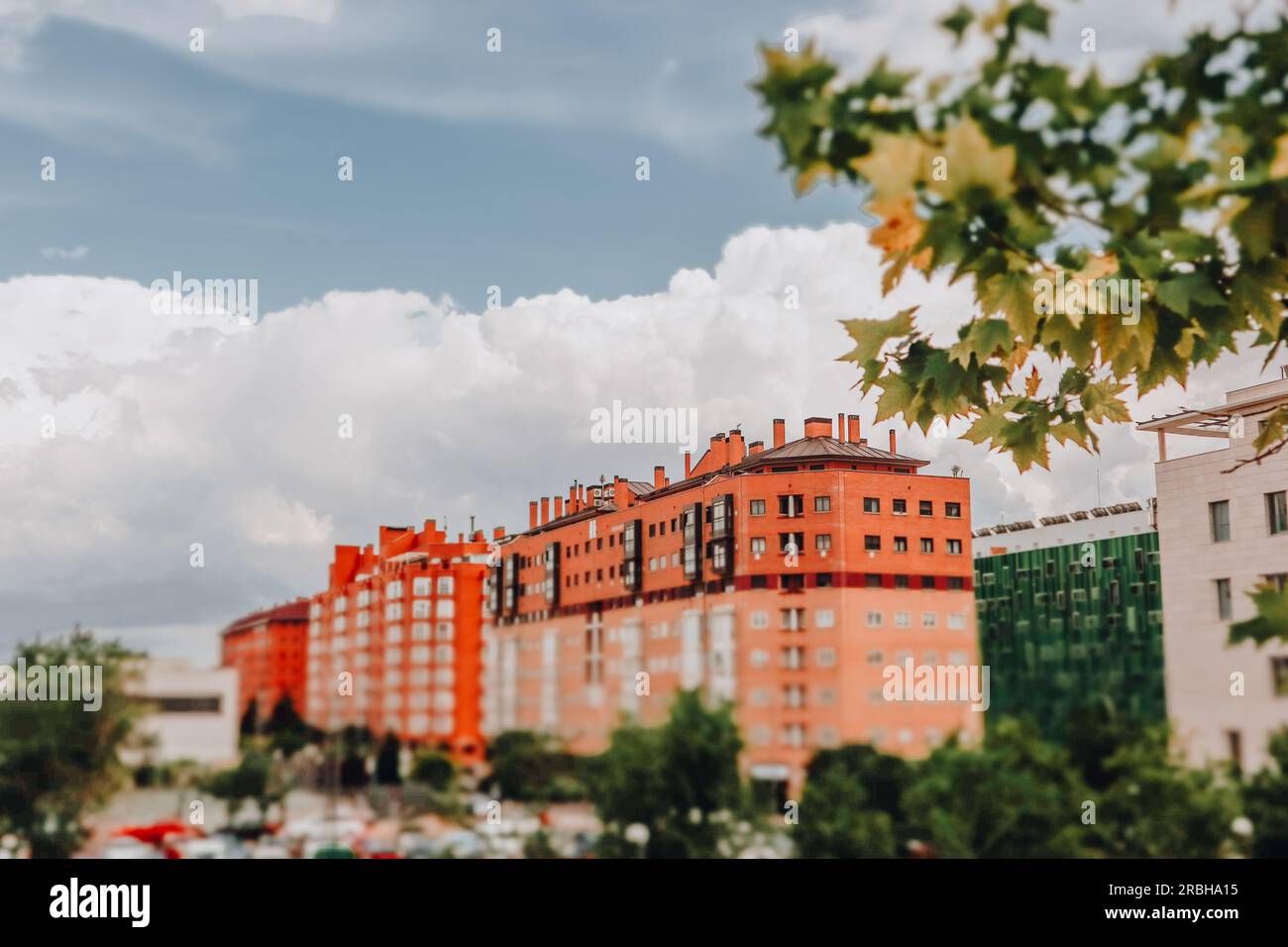 Multistory Apartment Building In Modern Residential Area Orange House Against In Green Area