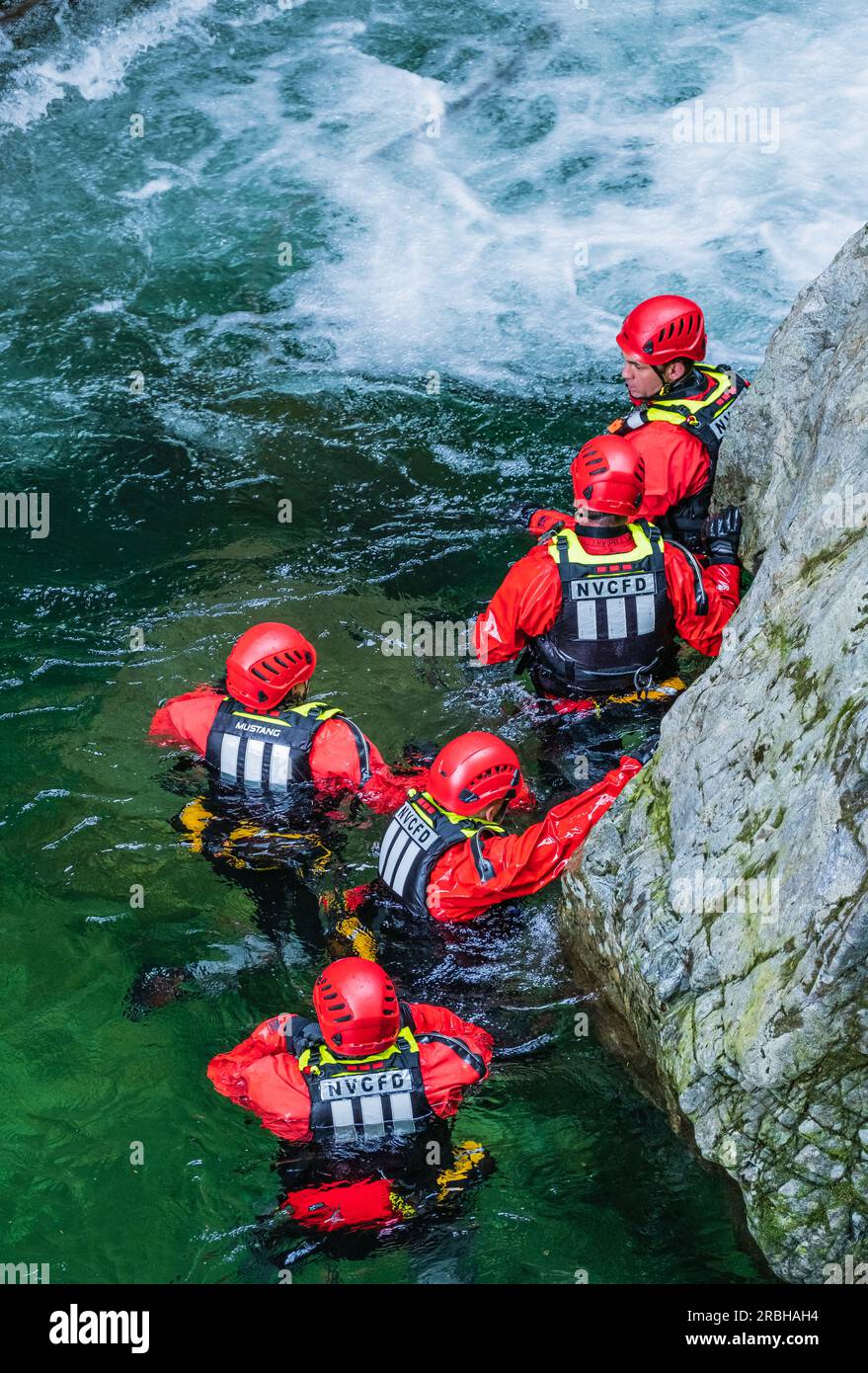 Fireman are training for rescue mission. Rescue team in action. A Fire and Rescue team working together to hone their life saving skills on a flooded Stock Photo