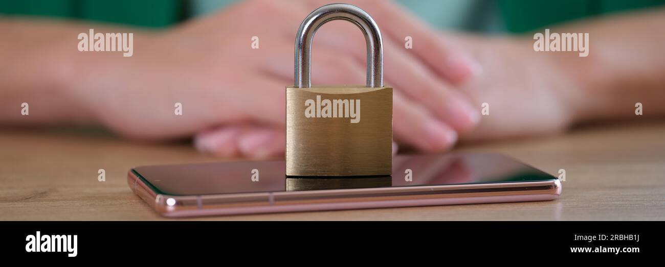 Closed metal padlock on smartphone, personal data security Stock Photo