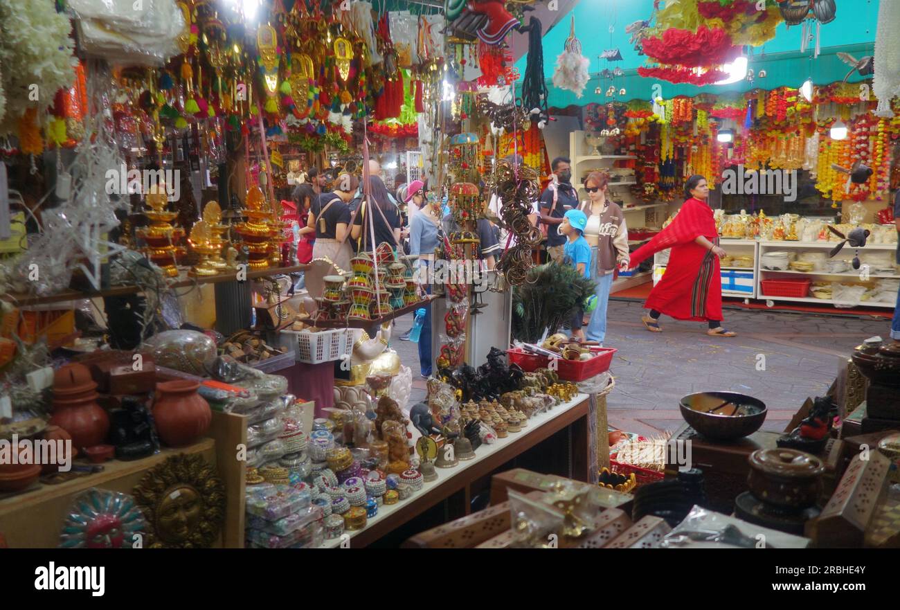 Woman in red sari walking past stalls in Campbell Lane, Little India, Singapore. No MR or PR Stock Photo