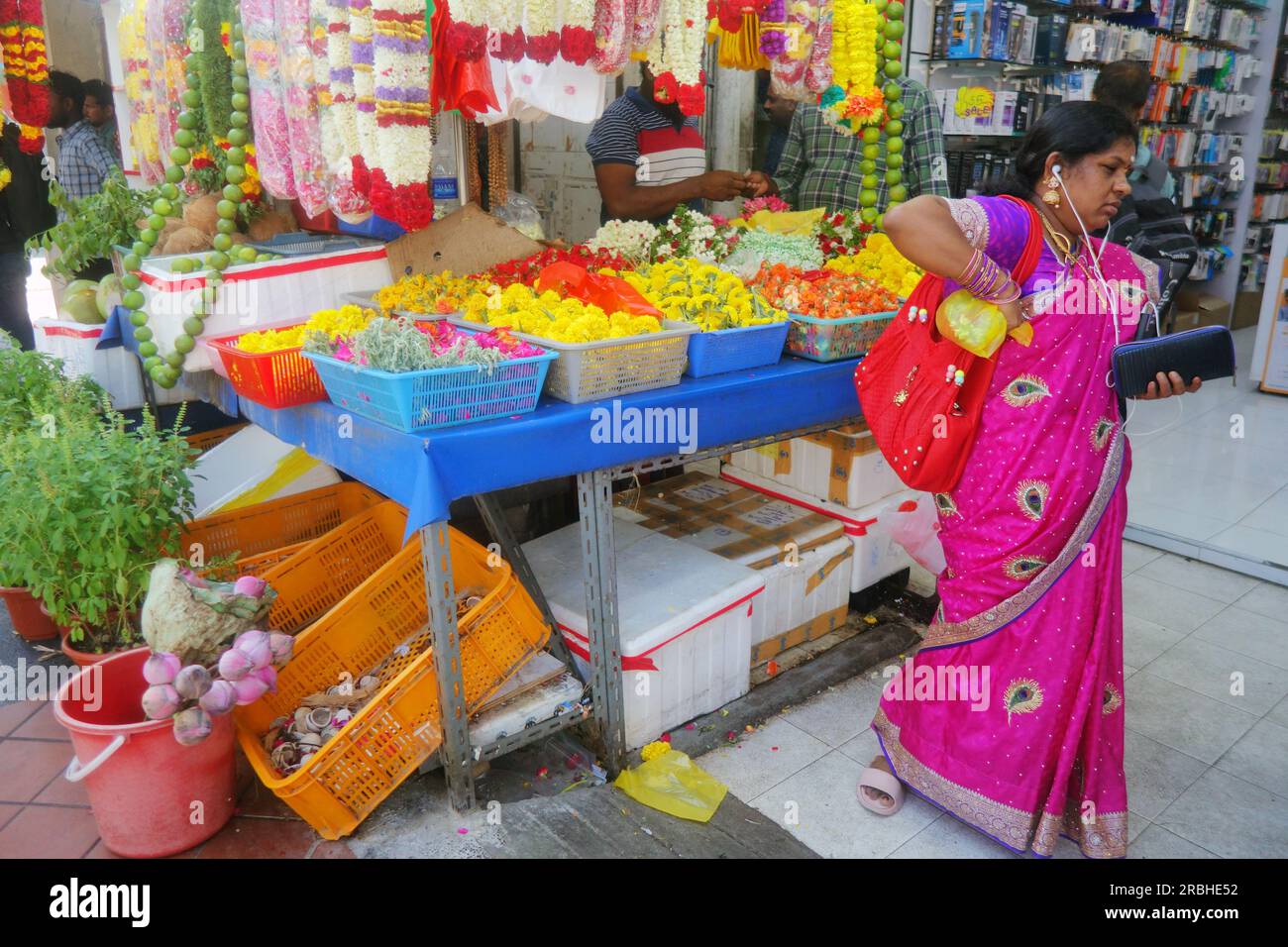 Woman shopping at offerings stall near temple, Little India, Singapore. No MR or PR Stock Photo
