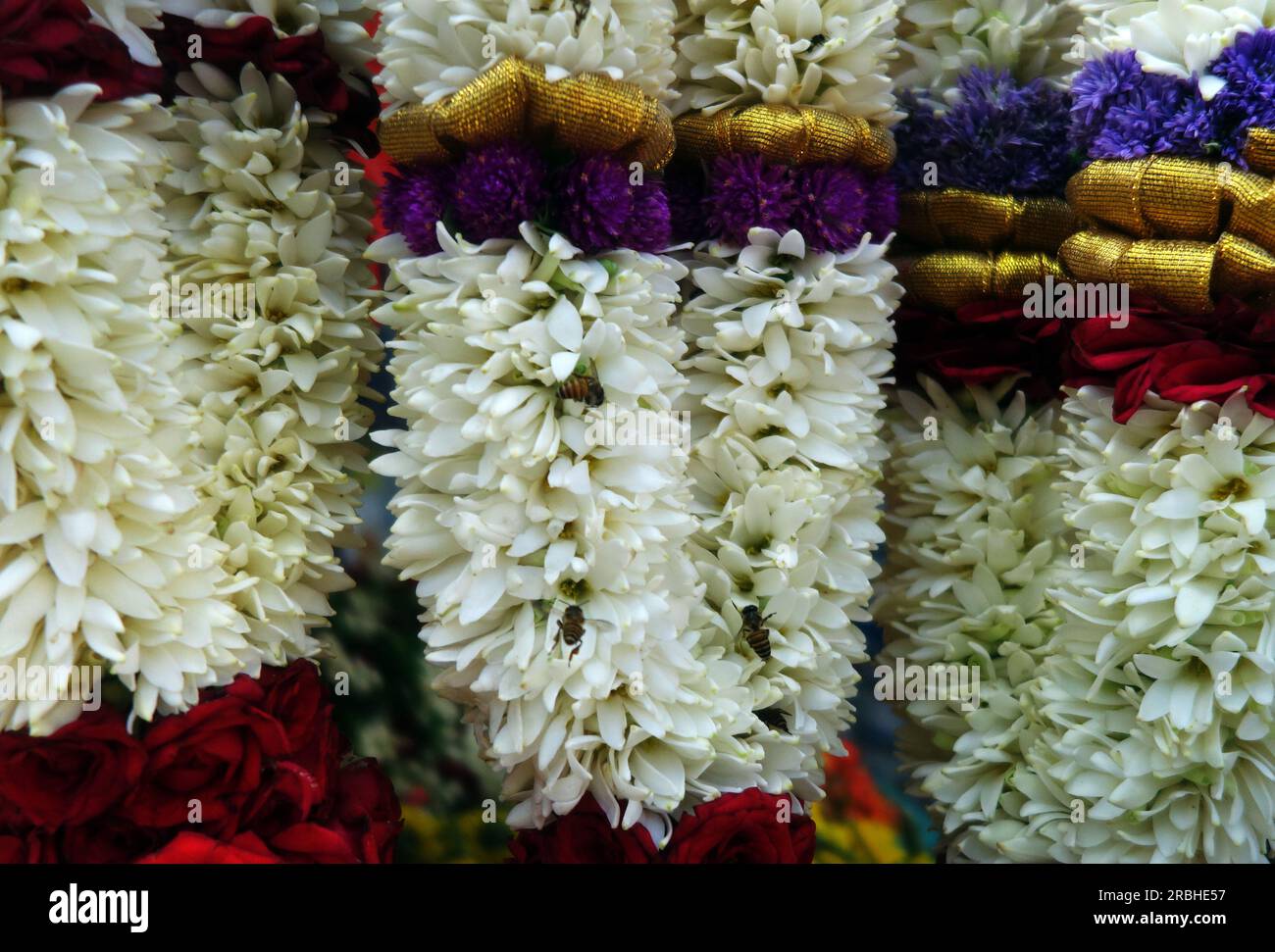 Asian honeybees going nuts in the Hindu floral offerings, Little India, Singapore Stock Photo