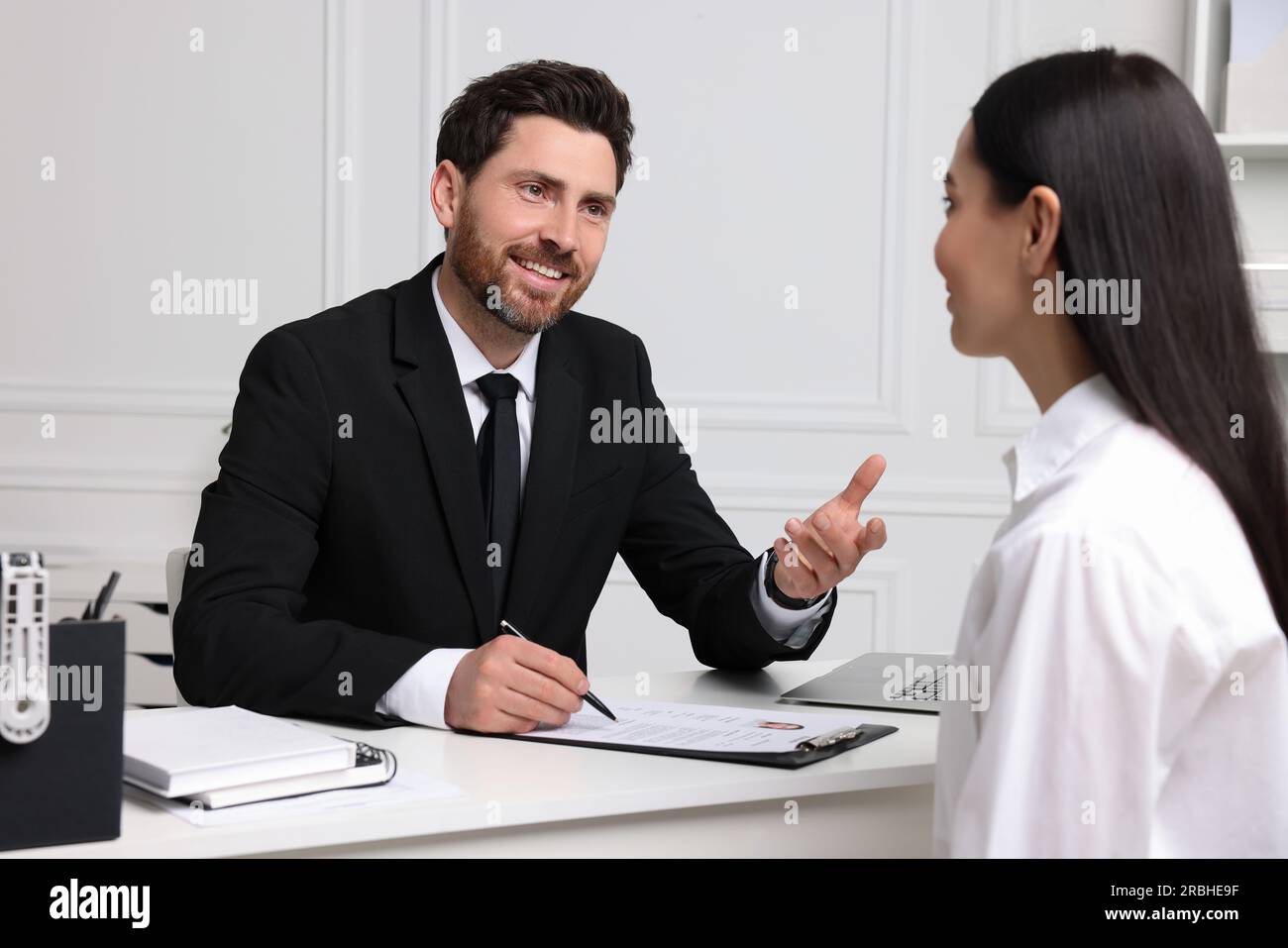 Human resources manager conducting job interview with applicant in ...