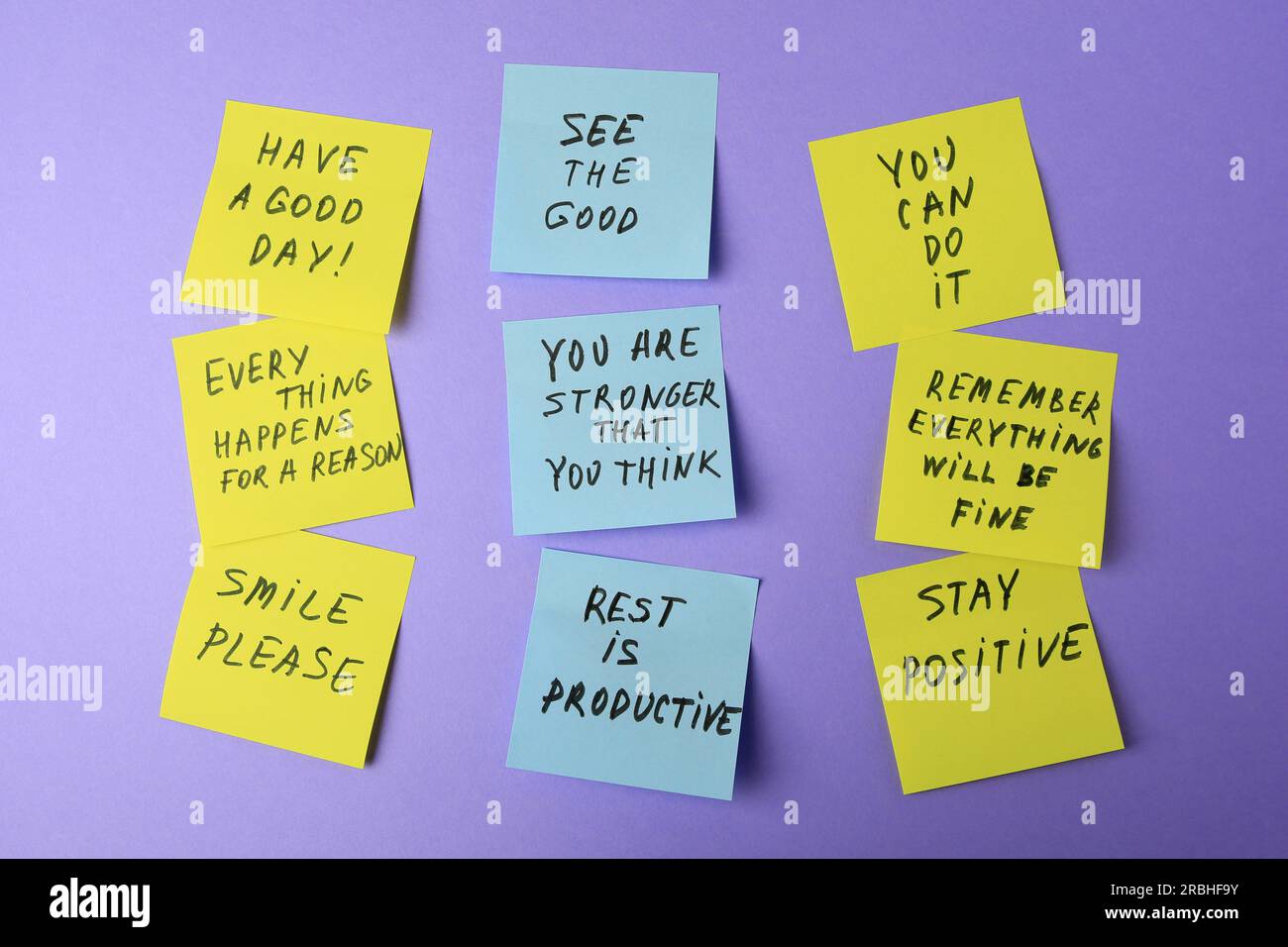 Paper notes with life-affirming phrases on violet background Stock Photo