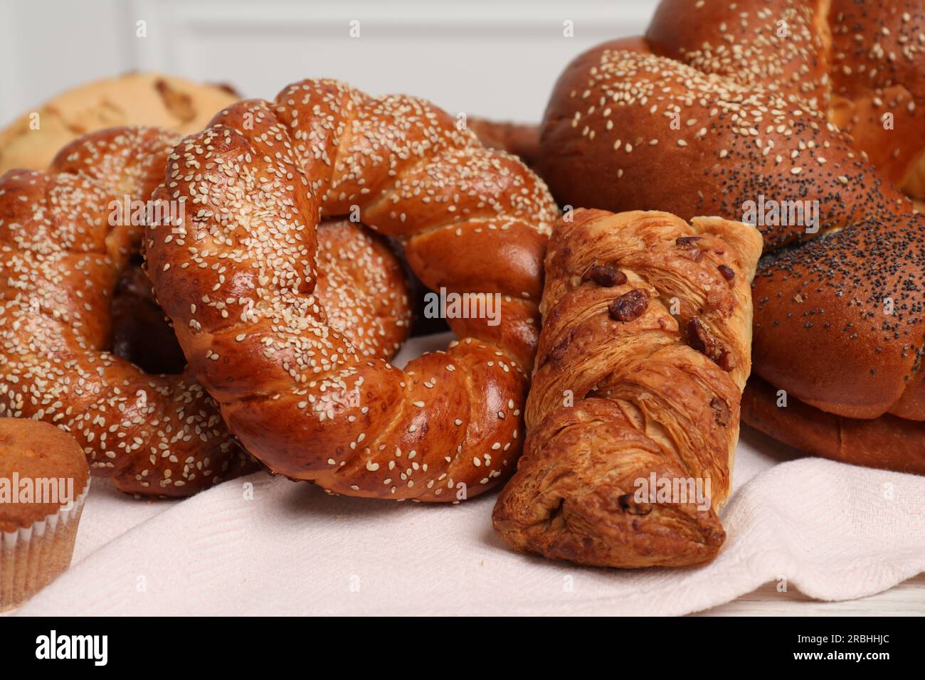 Different tasty freshly baked pastries on table, closeup Stock Photo