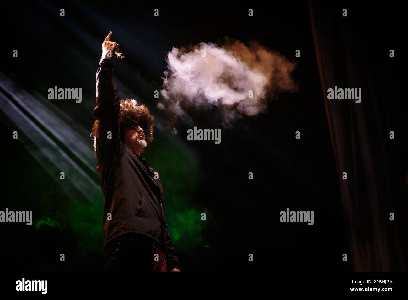 B-Real of Cypress Hill performs on stage sporting sunglasses, a large ...