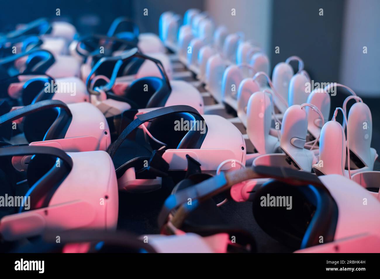 Virtual reality VR equipment on a table. VR headsets and joysticks