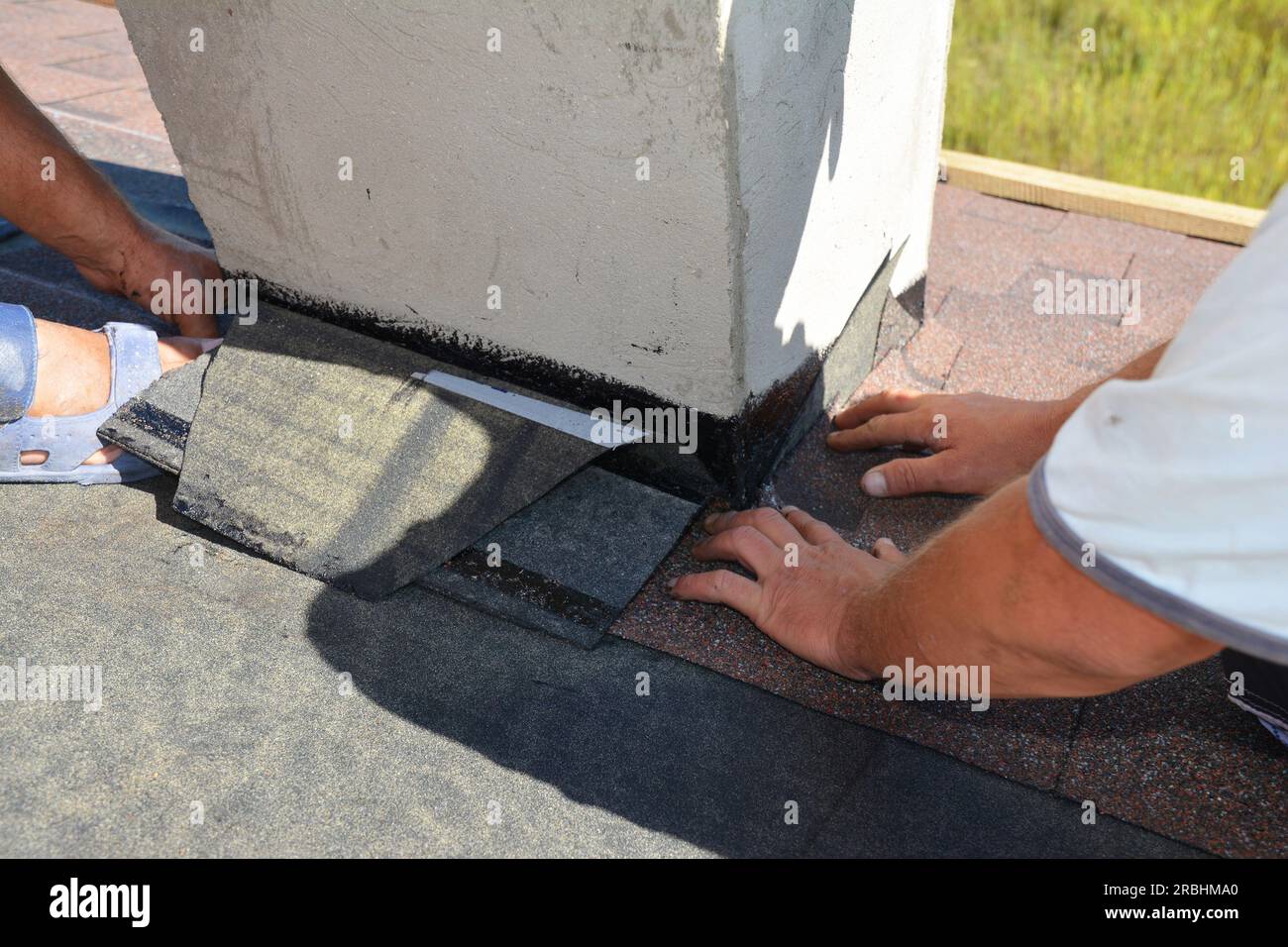 A closeup on a roofing construction, installation of asphalt shingles on roof sheathing around