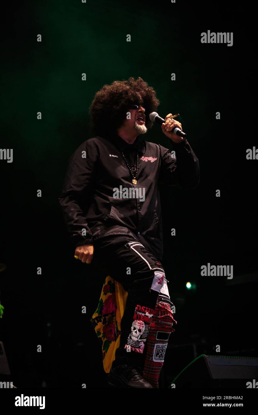 B-Real of Cypress Hill performs on stage sporting sunglasses, a large ...
