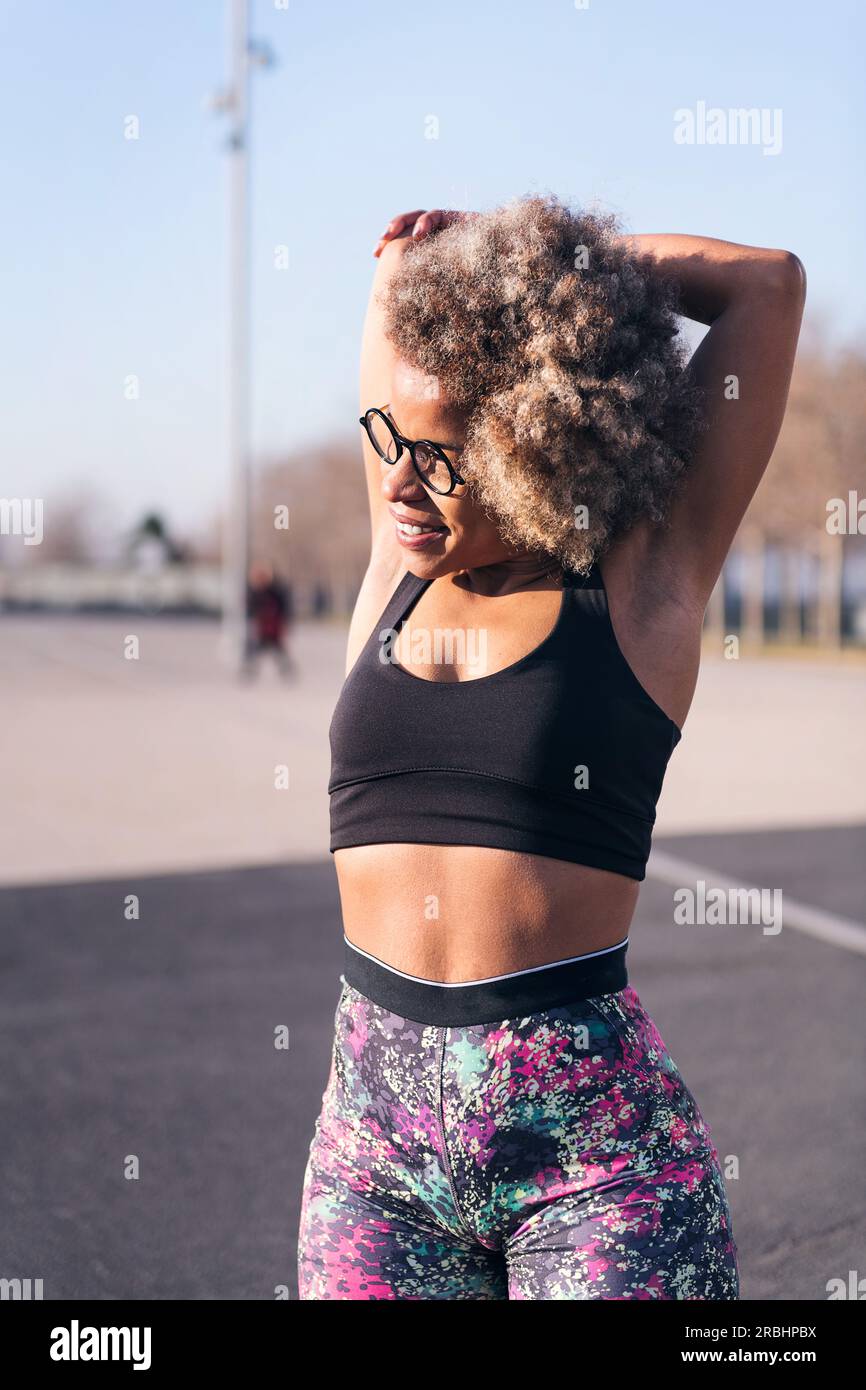 african fit woman stretching in an urban park Stock Photo - Alamy