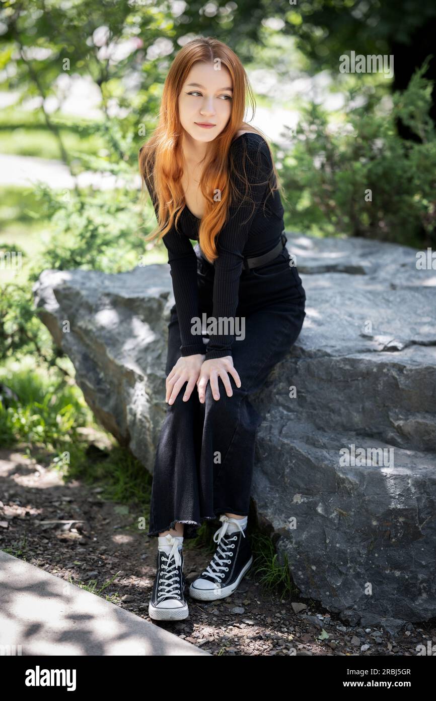Beautiful girl with red hair on a walk in the park Stock Photo - Alamy
