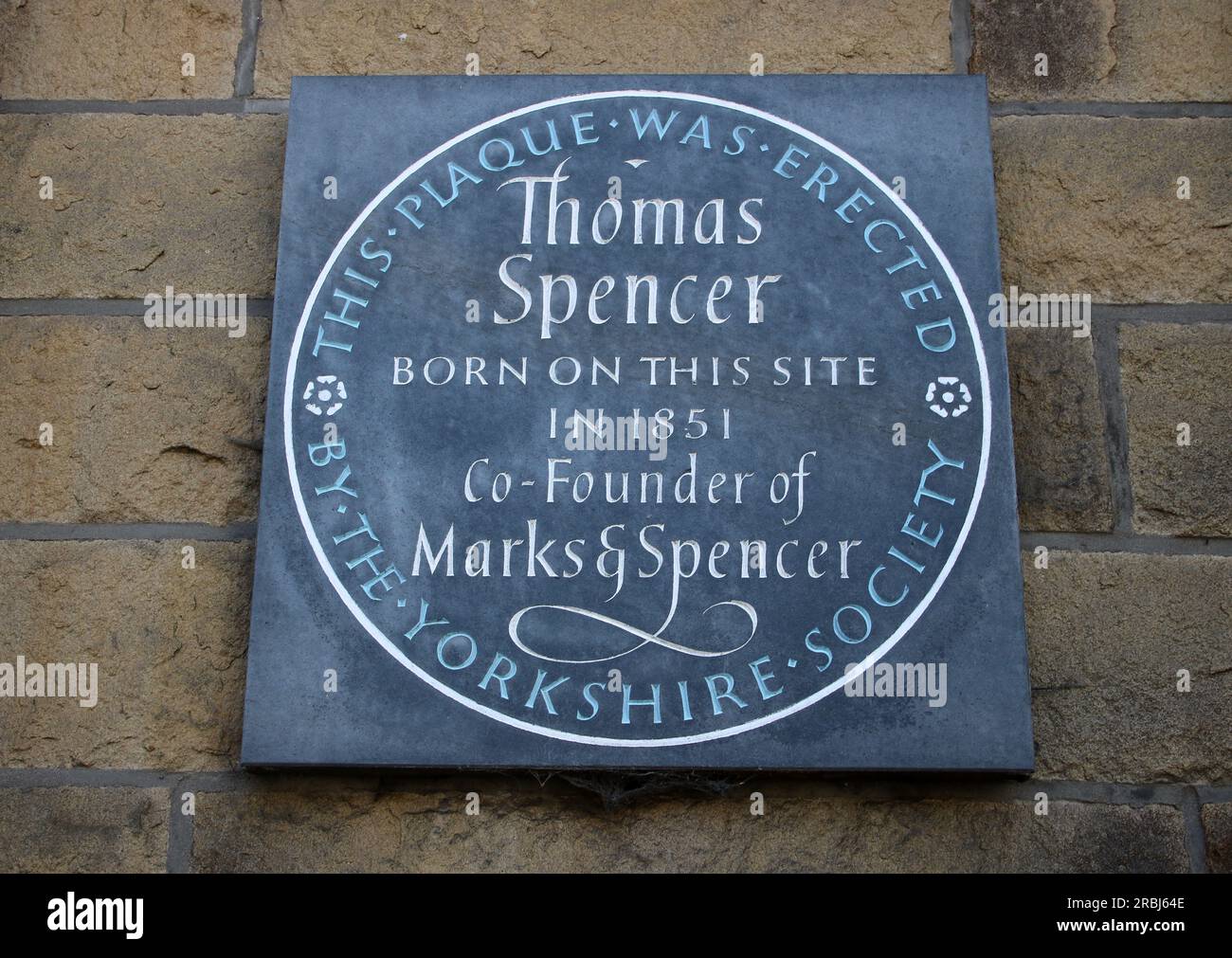 Plaque erected by Yorkshire Society to mark birth place of Thomas Spencer, Co-Founder of Marks and Spencer. Plaque on wall Newmarket Street Skipton. Stock Photo